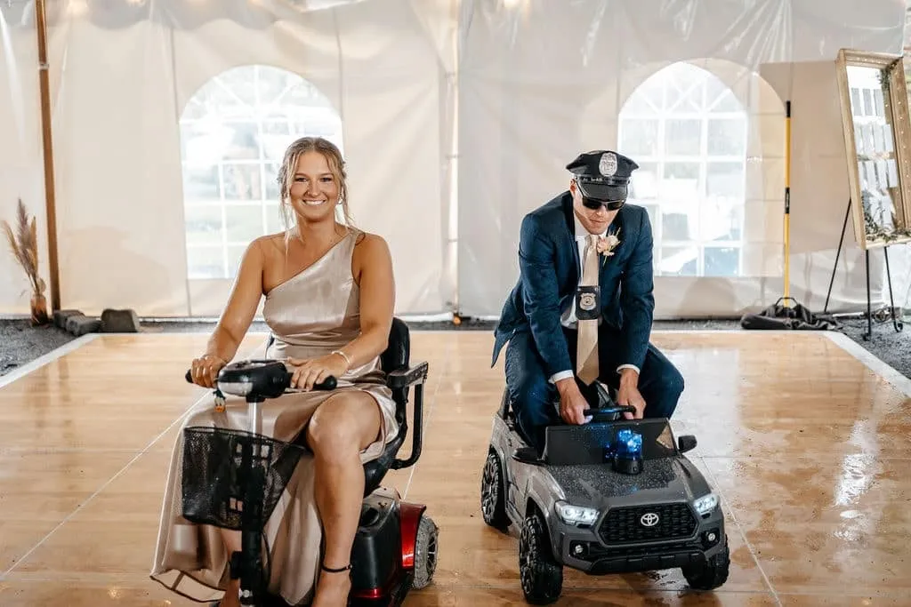 Couple riding a car toy for wedding entrance | Love in Focus Studio