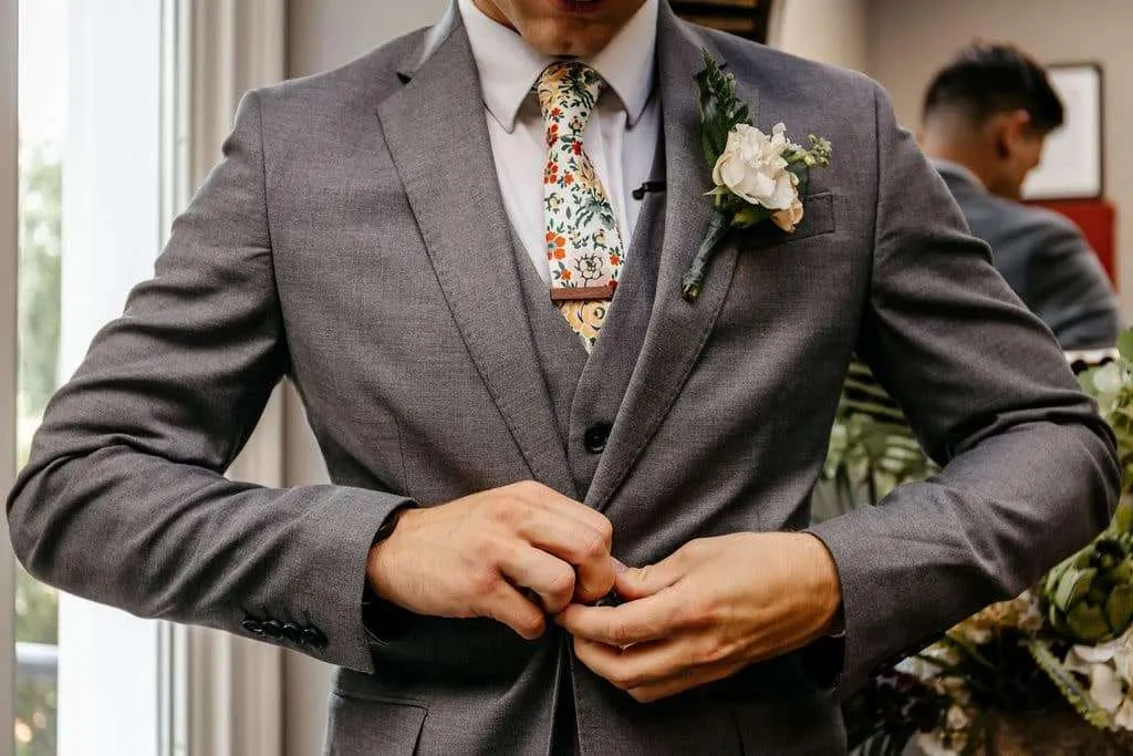 Groom buttoning his suit | Love in Focus Studio
