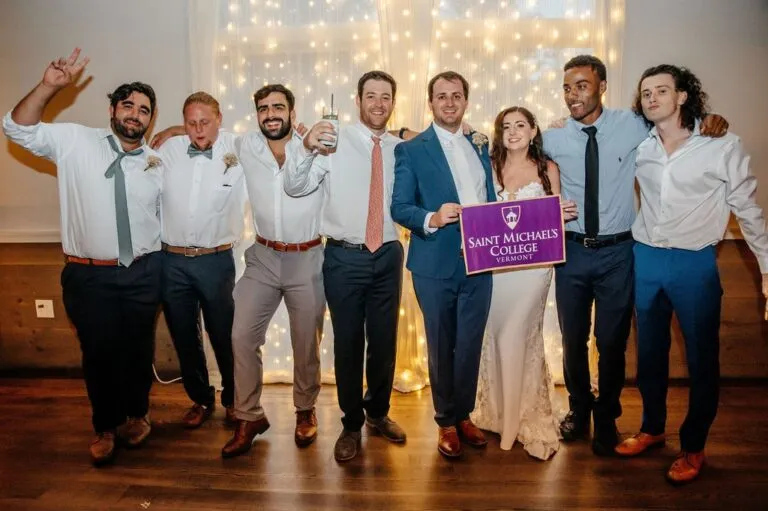 Wedding party photo of bride and groom with groomsmen at reception | Love in Focus Studio