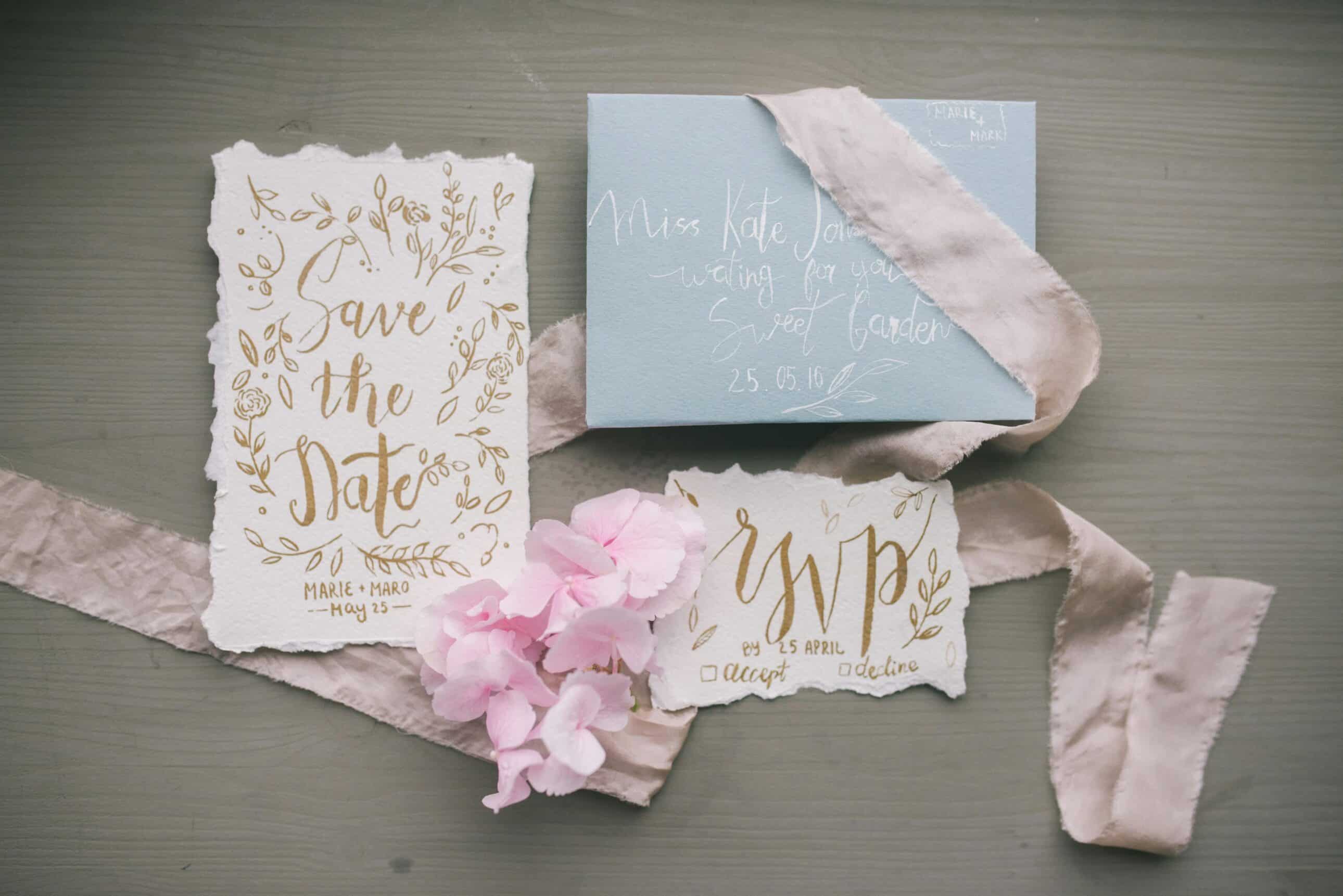 Flat lay of wedding invitation ideas for New England weddings with rustic floral accents