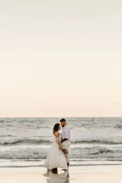 bride and groom share a romantic moment on the beach at the Ocean House in Watch Hill, Rhode Island