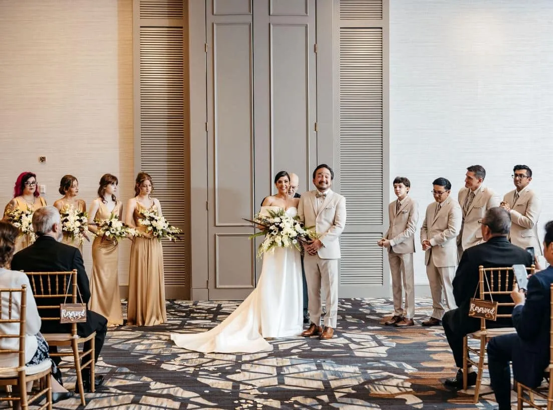 An indoor wedding ceremony at the Boston Marriott Burlington in Massachusetts, with the couple standing at the altar.