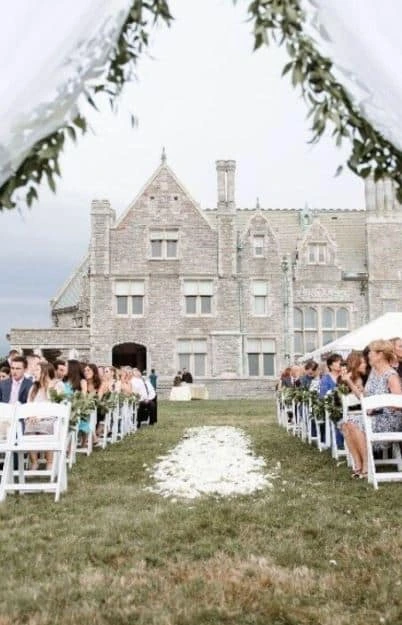 An outdoor wedding ceremony at The Branford House at UConn Avery Point in Groton, CT, with a view down the aisle.