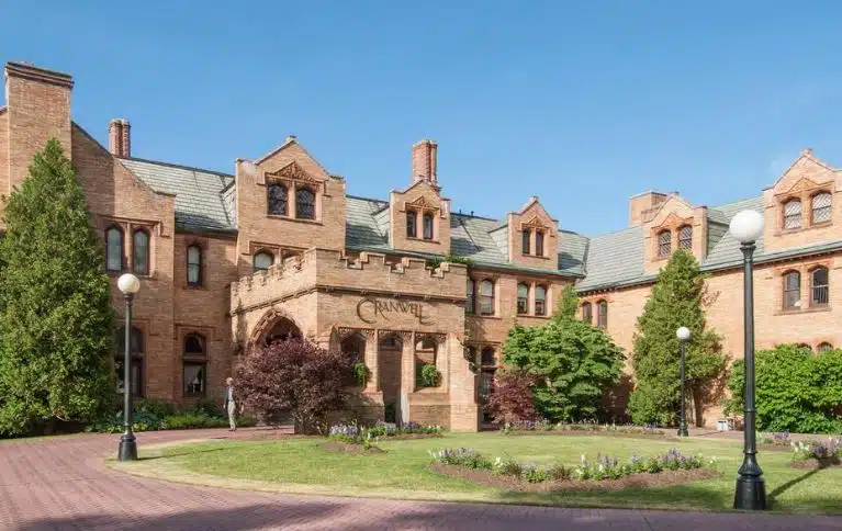 The historic brick exterior of Cranwell Spa & Golf Resort in Lenox, Massachusetts, a wedding venue in the Berkshire Hills.