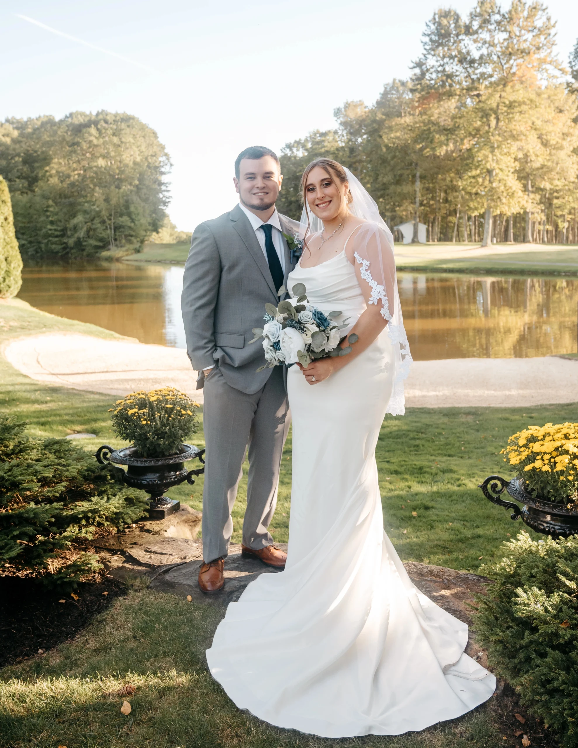 A bride and groom pose for a photo on the golf course at Atkinson Resort & Country Club in New Hampshire.