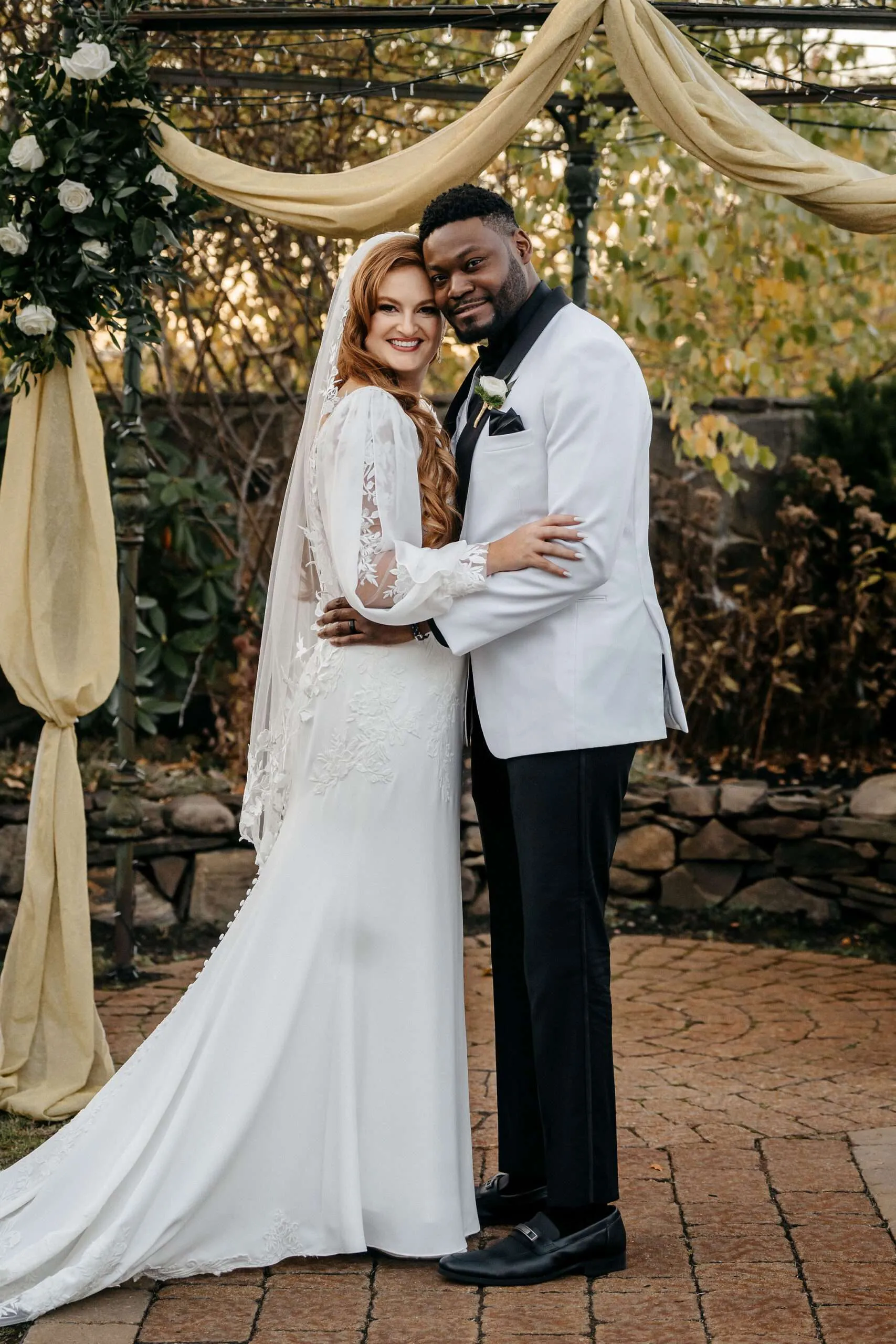 Couple embracing at wedding ceremony.