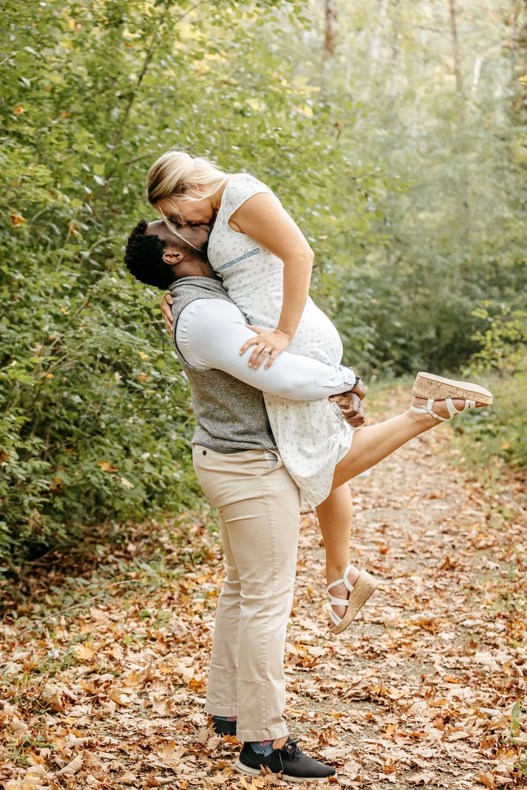 Couple embracing in a forest path