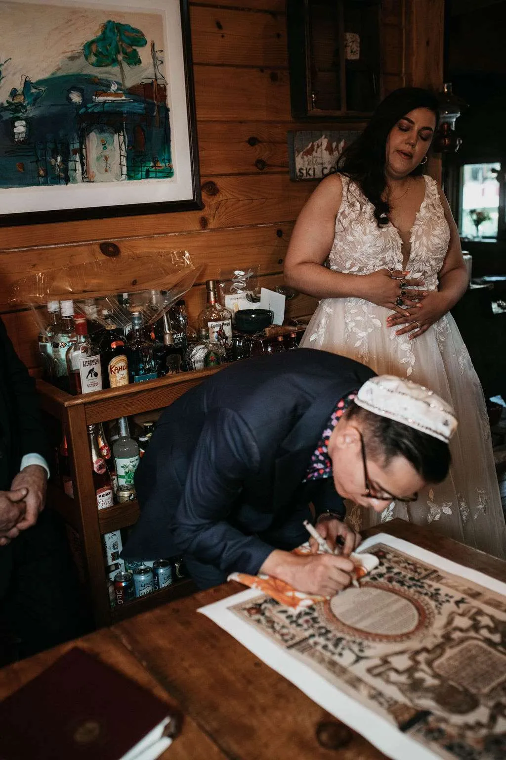 Groom signing the Ketubah at Moose Pond Cabin in Townshend, Vermont.