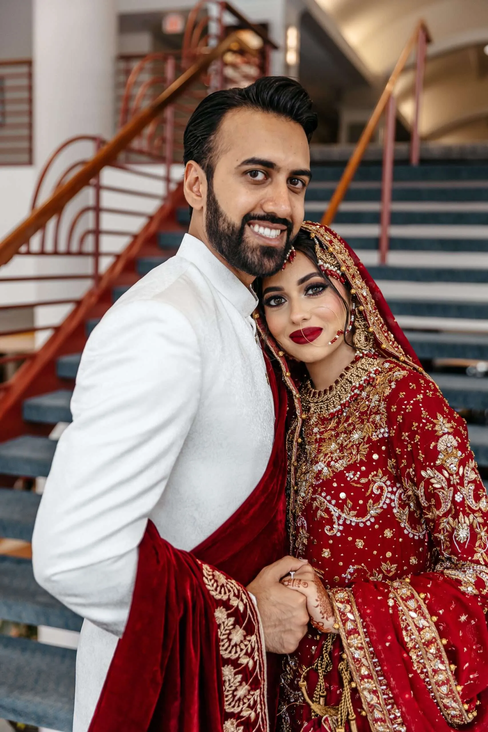 Relaxed portrait of Fizza leaning over Hasan's shoulder after their vibrant Mehndi night celebration.