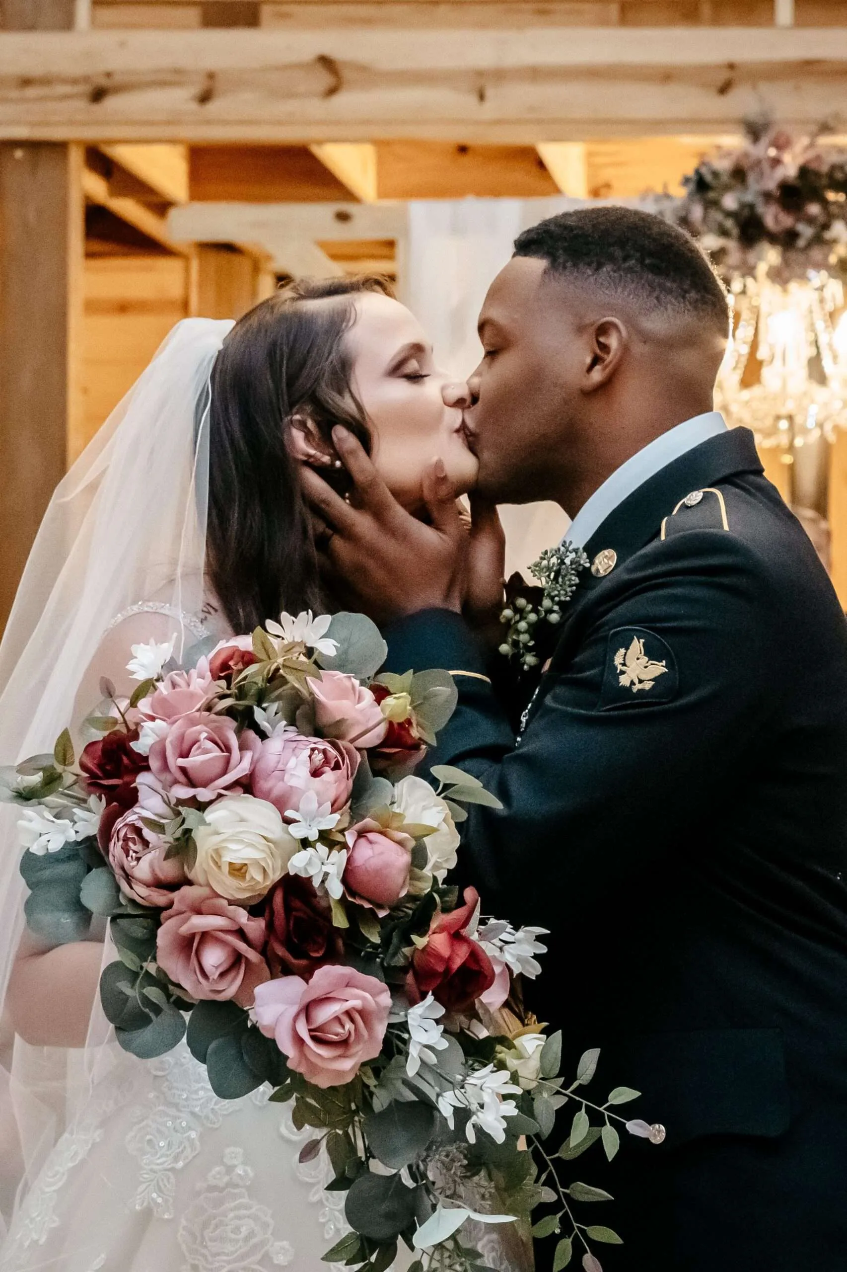 Kristy and Hershel posing for a romantic portrait during their military wedding celebration.