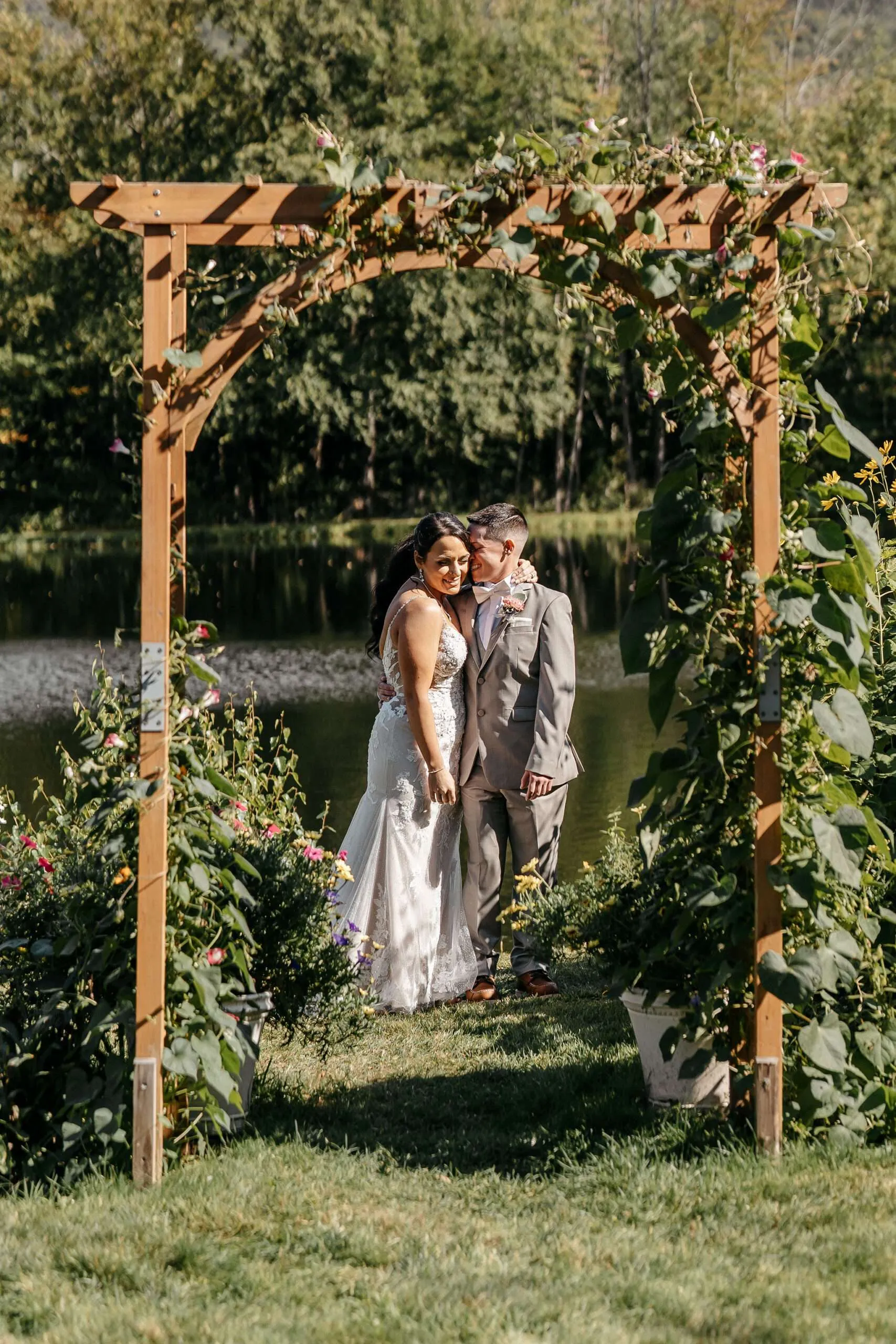 Kyleigh and Sam sharing a moment during their lesbian wedding photography session in Lincoln, NH.