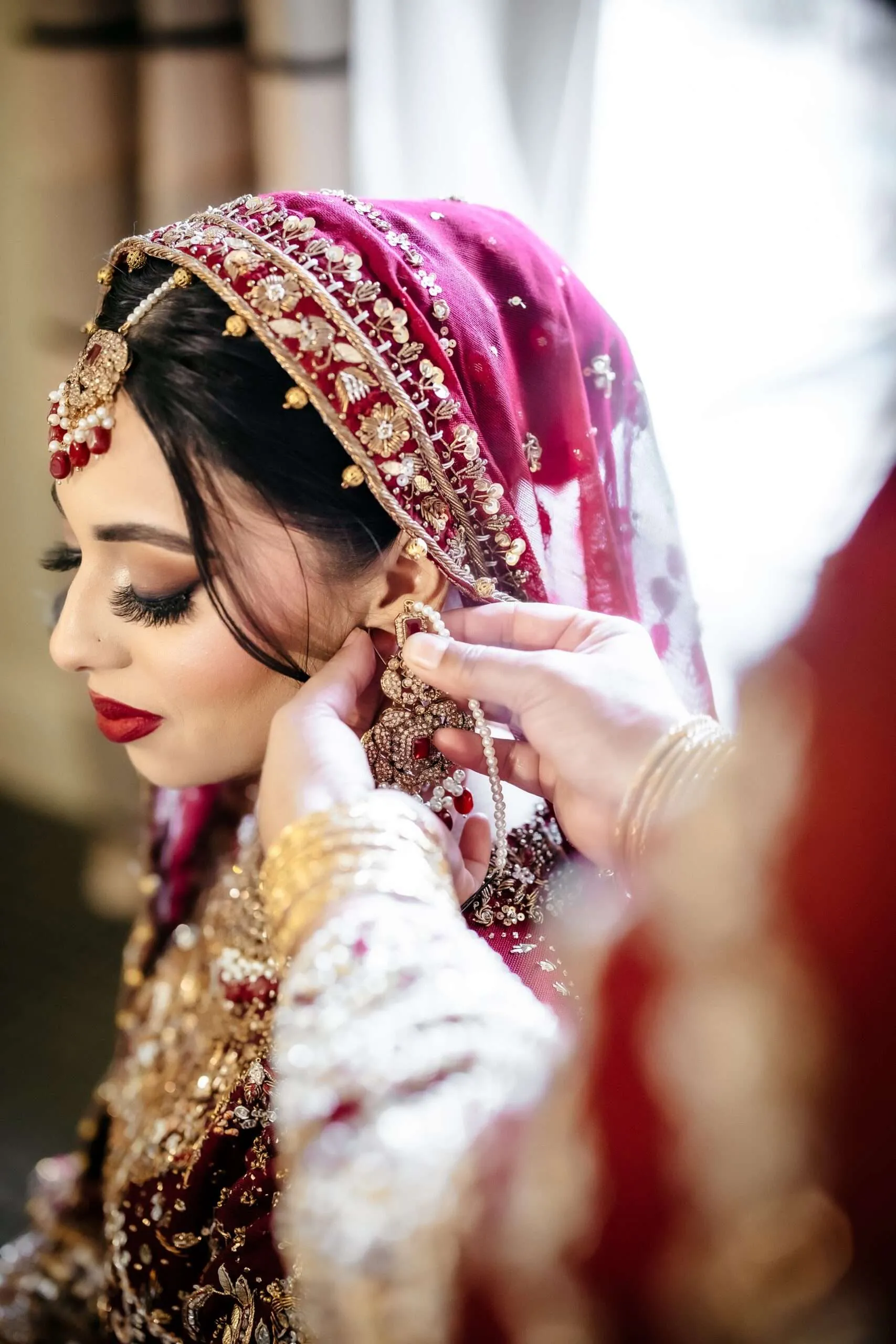 Elegant portrait of Fizza getting ready before the Nikah, showcasing beautiful Desi attire and jewelry.