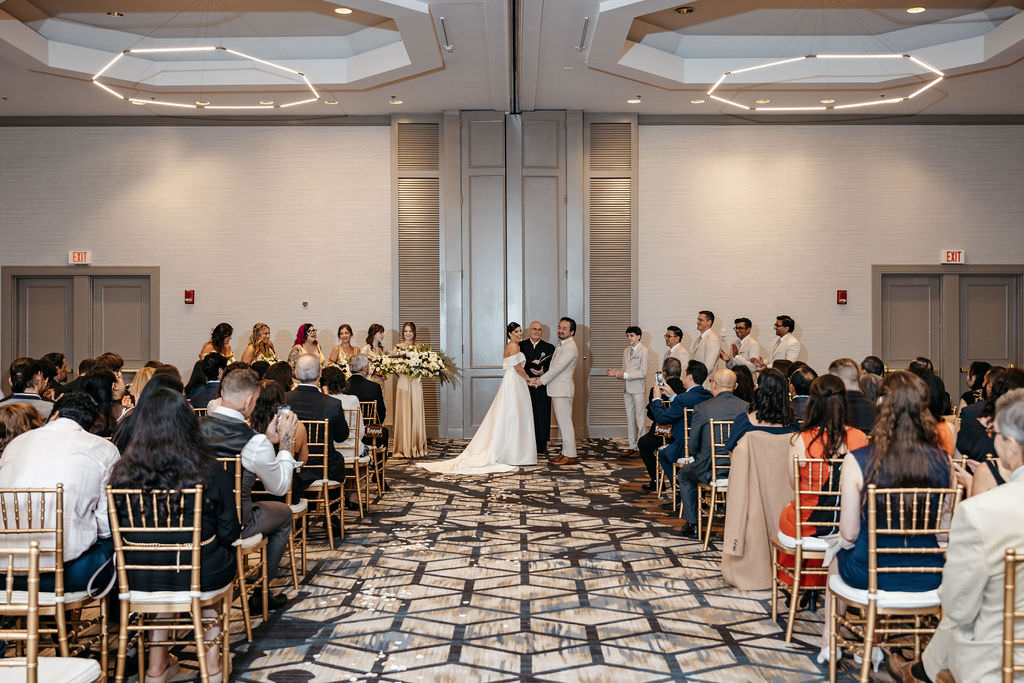 Wide view of a ballroom wedding ceremony at the Boston Marriott Burlington
