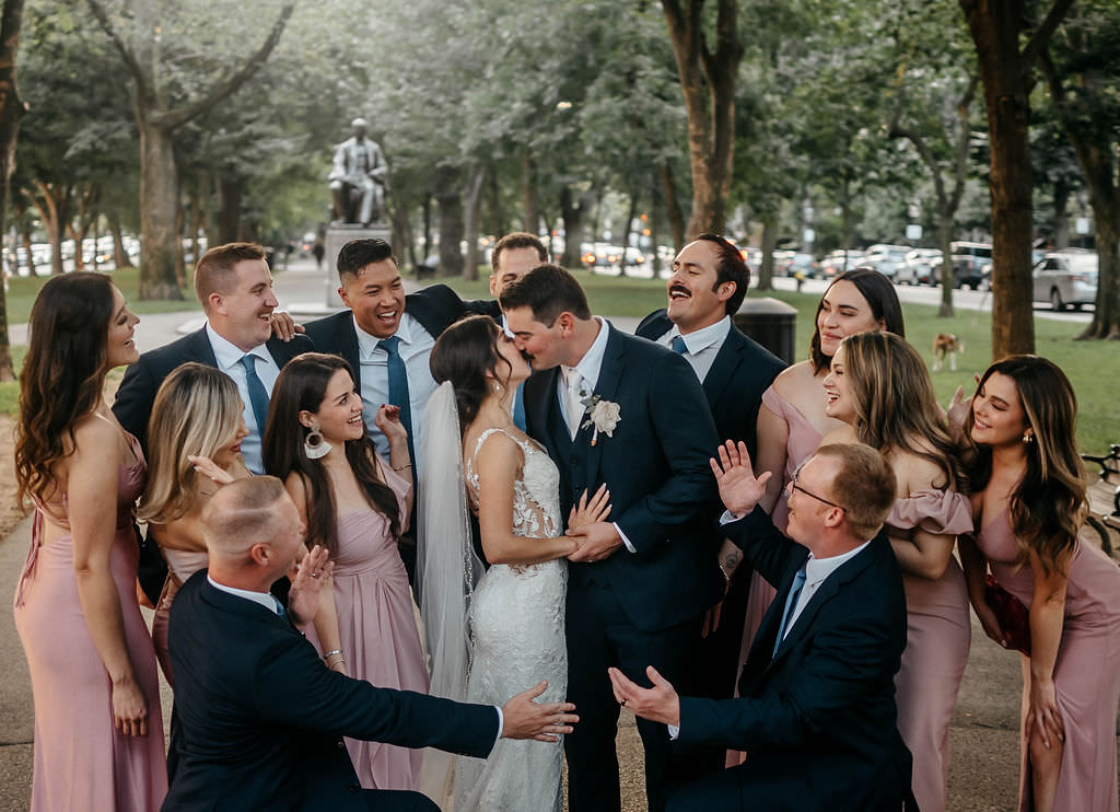 Getting married in Boston with a wedding party surrounding the couple.