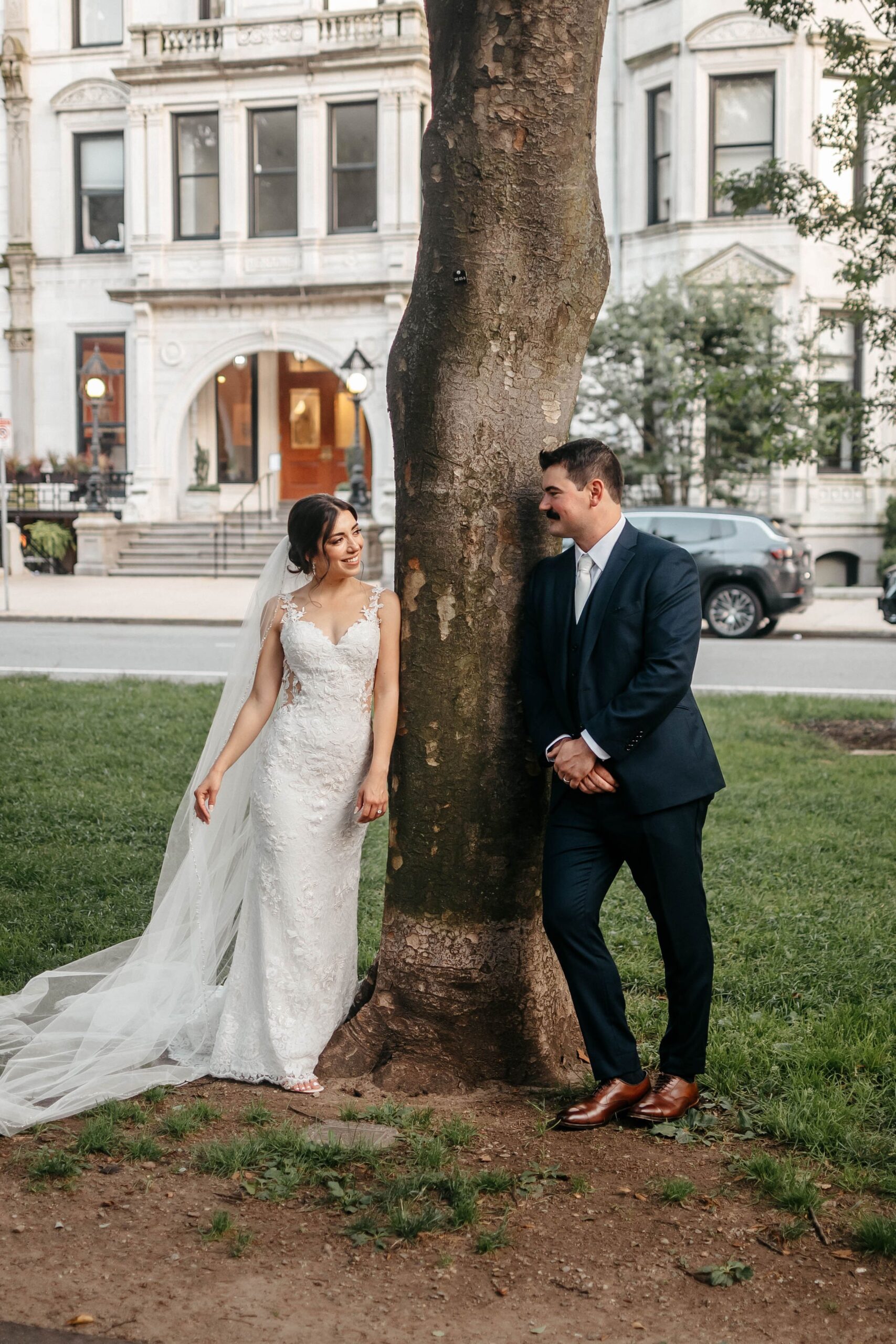 Bride and groom portrait by tree near Boston hotel wedding venue, elegant couple photo in city setting