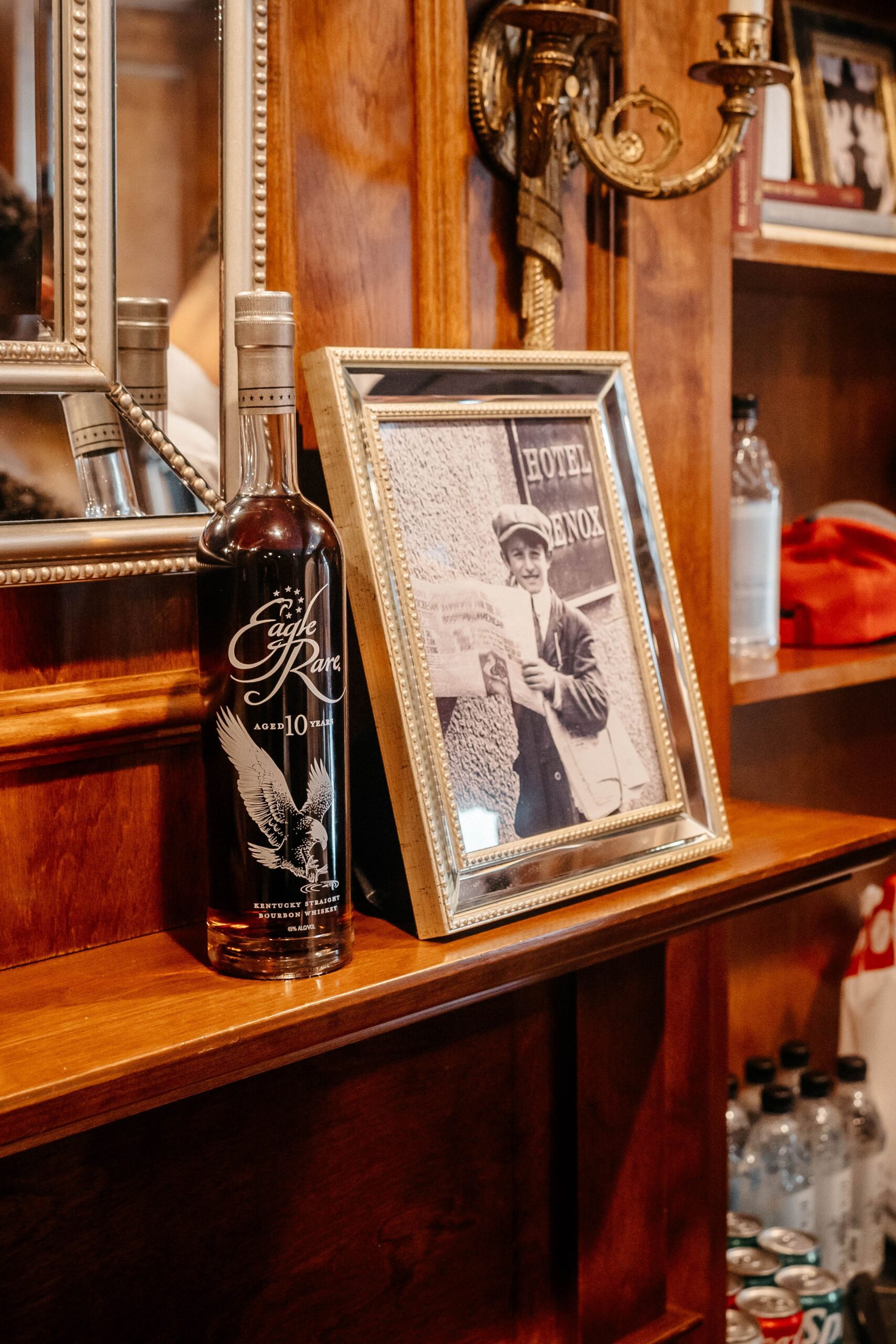 Wedding details at Boston hotel wedding venue featuring bourbon bottle and vintage photo in elegant suite