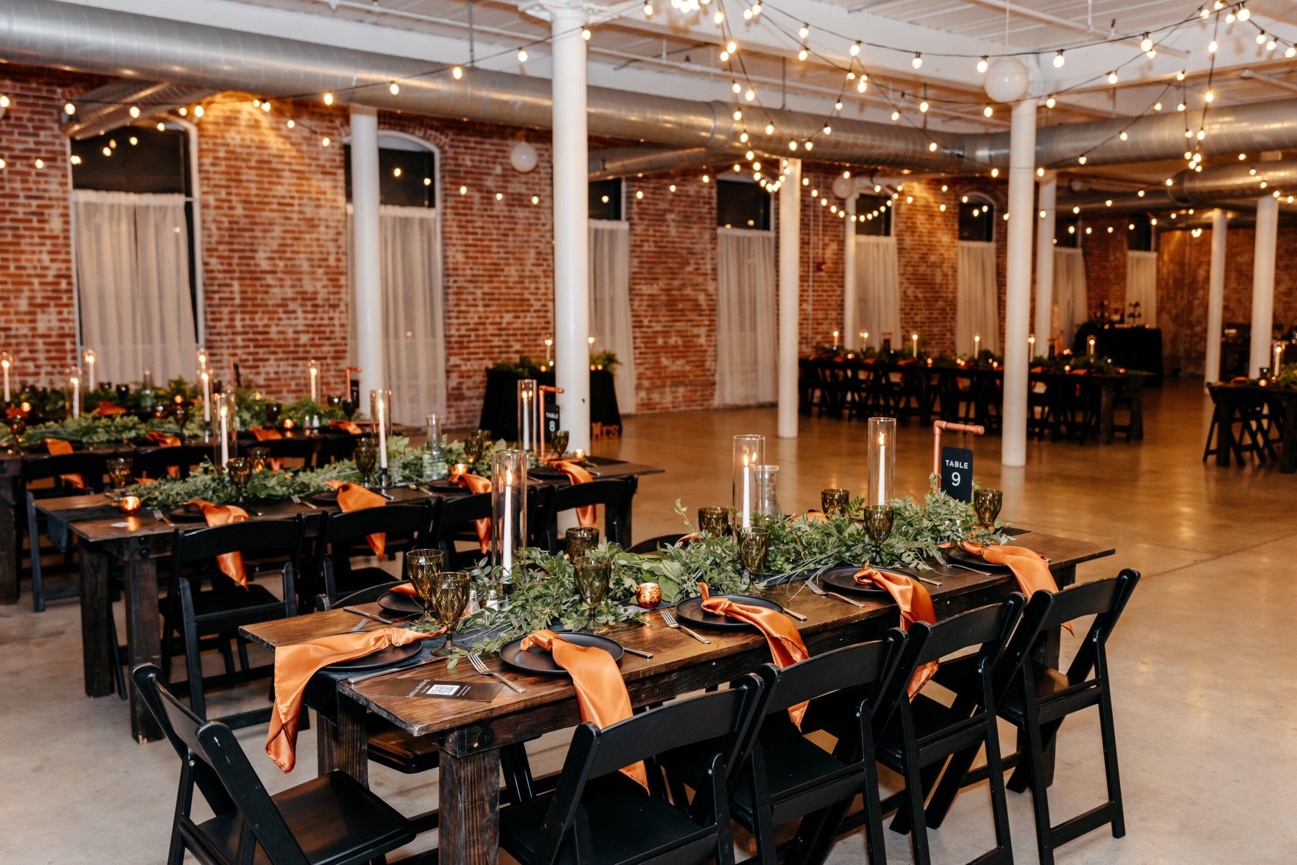 Reception setup with long tables and string lights showcasing elegant Boston wedding planning decor