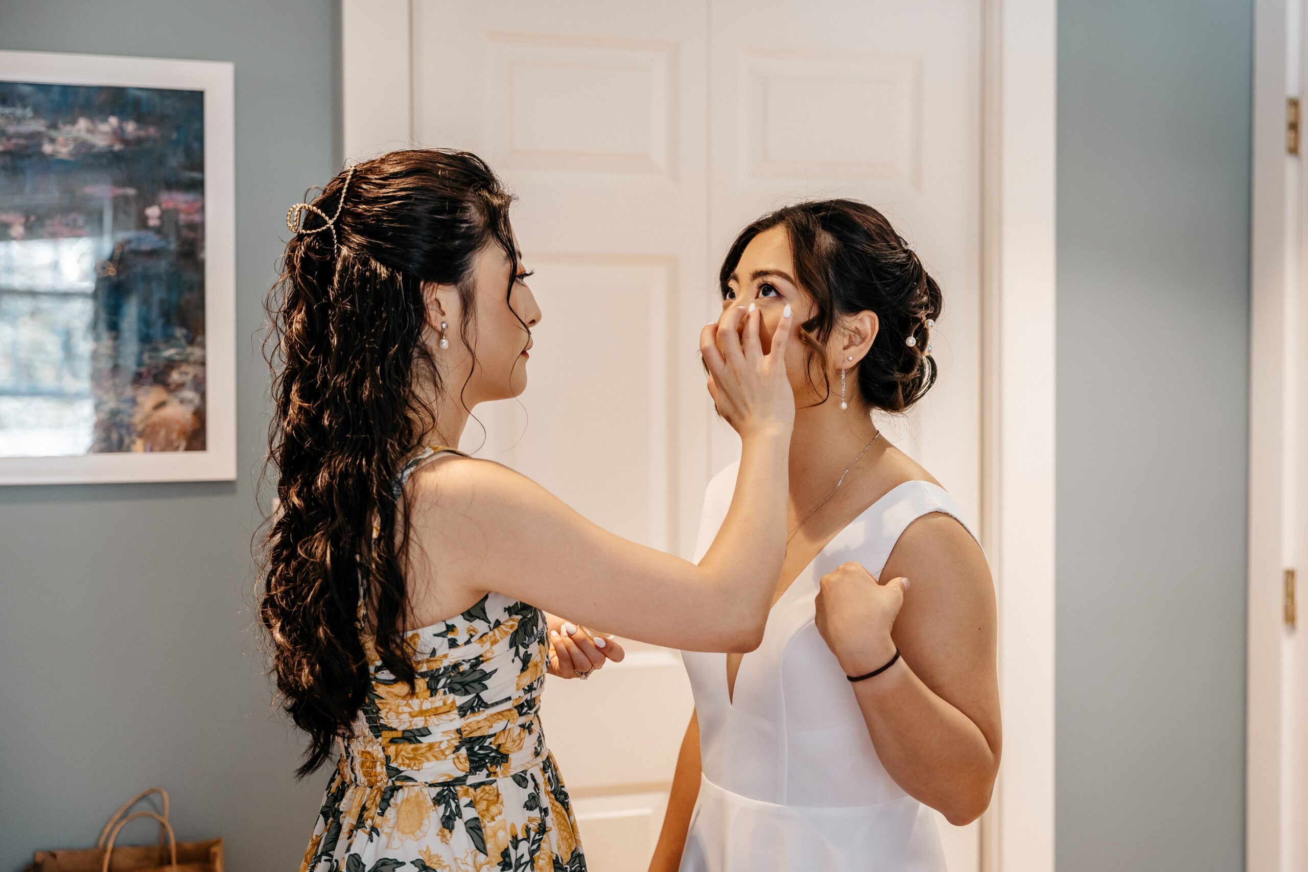 Bride getting makeup touch-up during wedding planning in Boston before ceremony