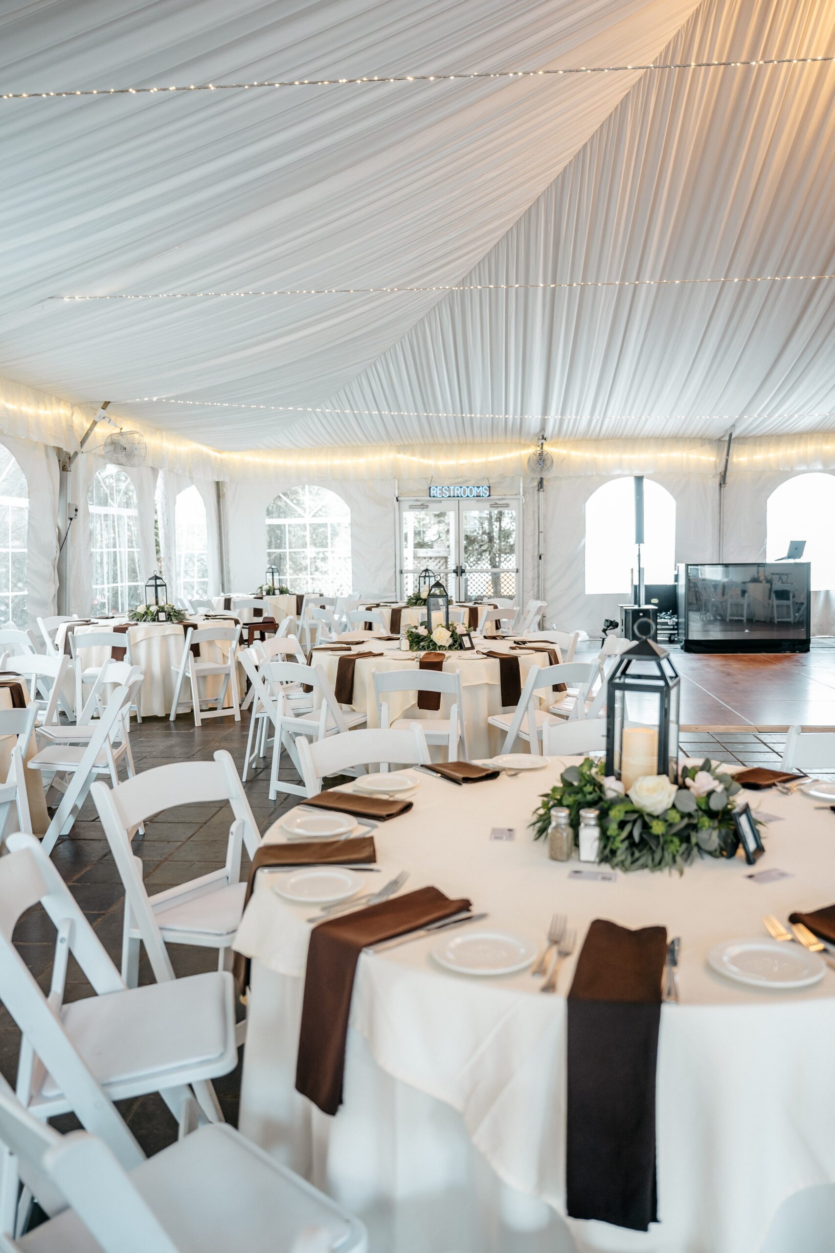 Elegant reception tent setup showcasing Boston wedding planning with decorated tables and lighting