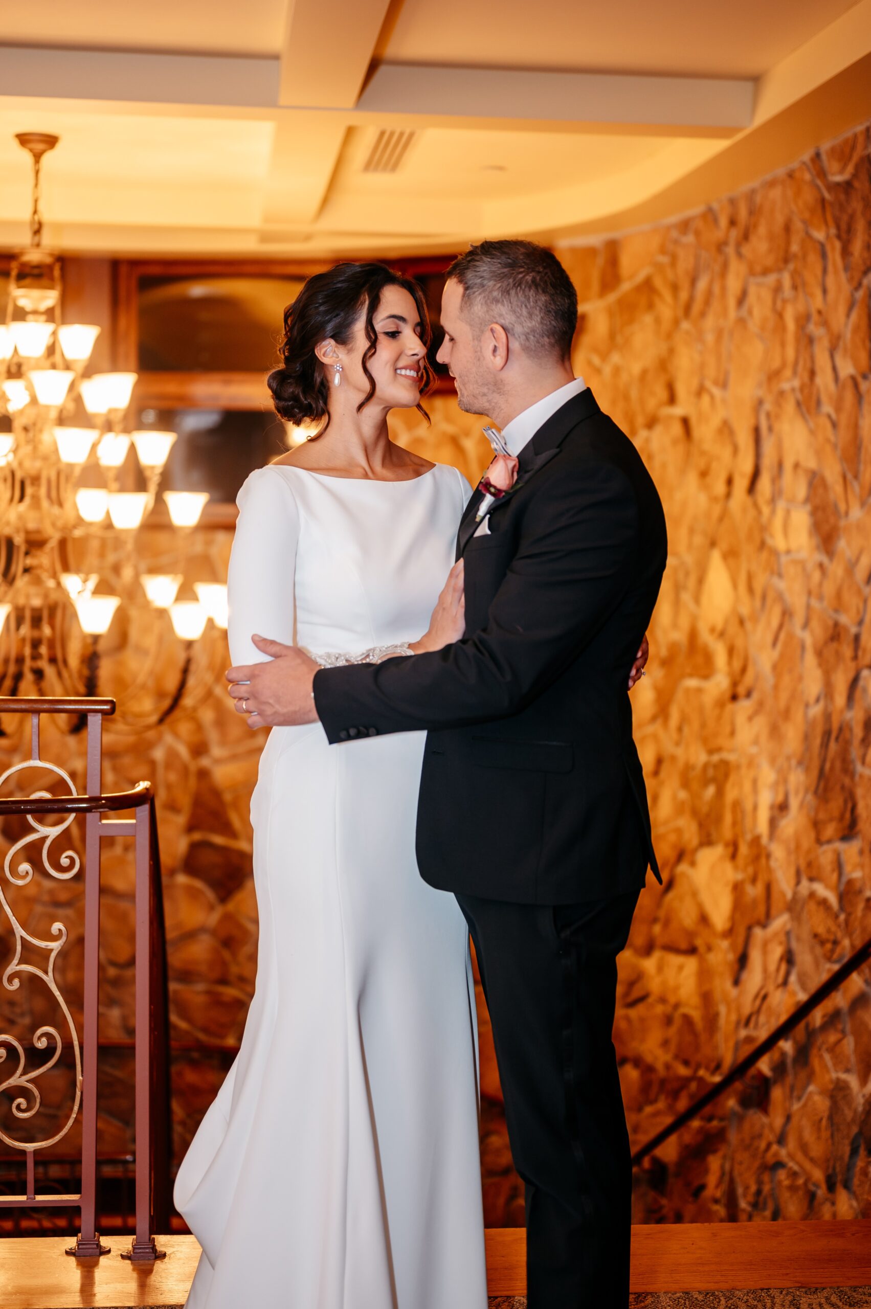 Bride and groom embracing on staircase during Boston wedding planning portrait