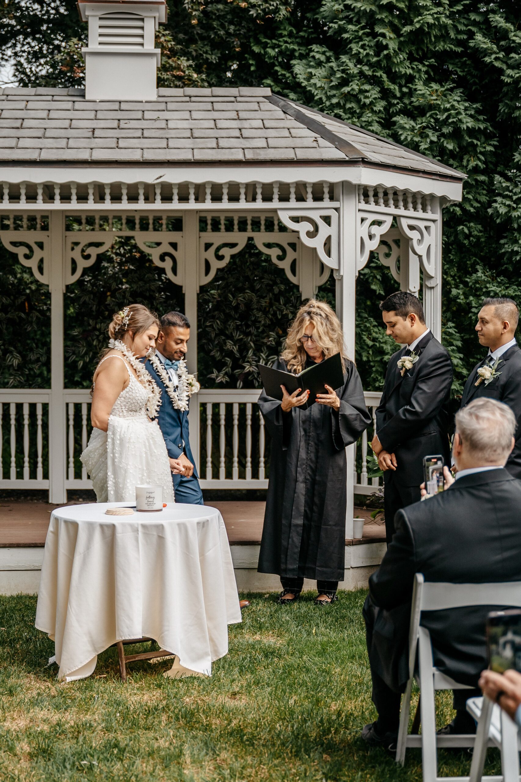 Outdoor ceremony at gazebo during wedding planning in Boston with couple and officiant