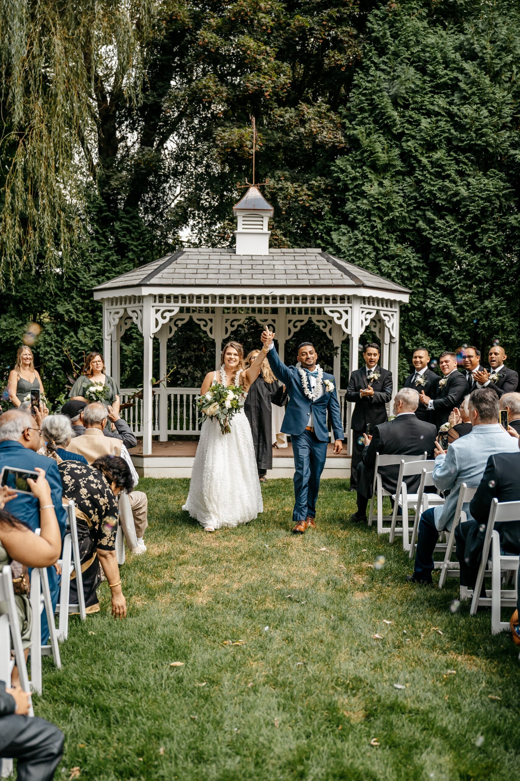 Newlyweds celebrating down the aisle after ceremony during Boston wedding planning event