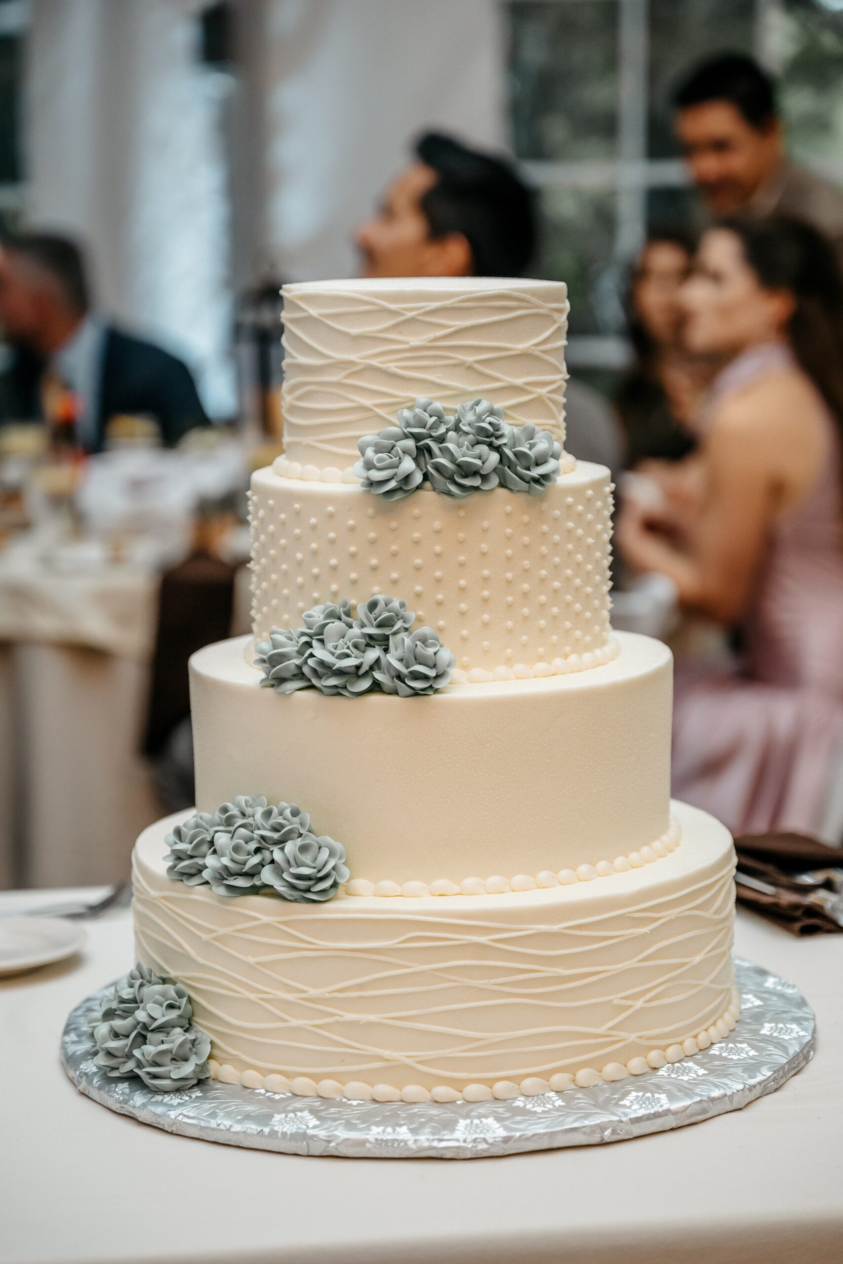 Three-tier wedding cake display at Boston wedding reception planned with elegant details