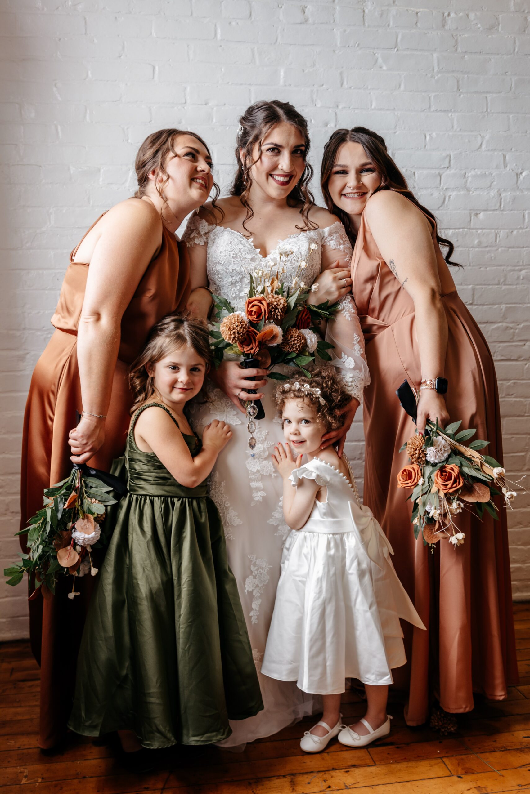Bride posing with bridesmaids and flower girls during Boston wedding planning portrait session