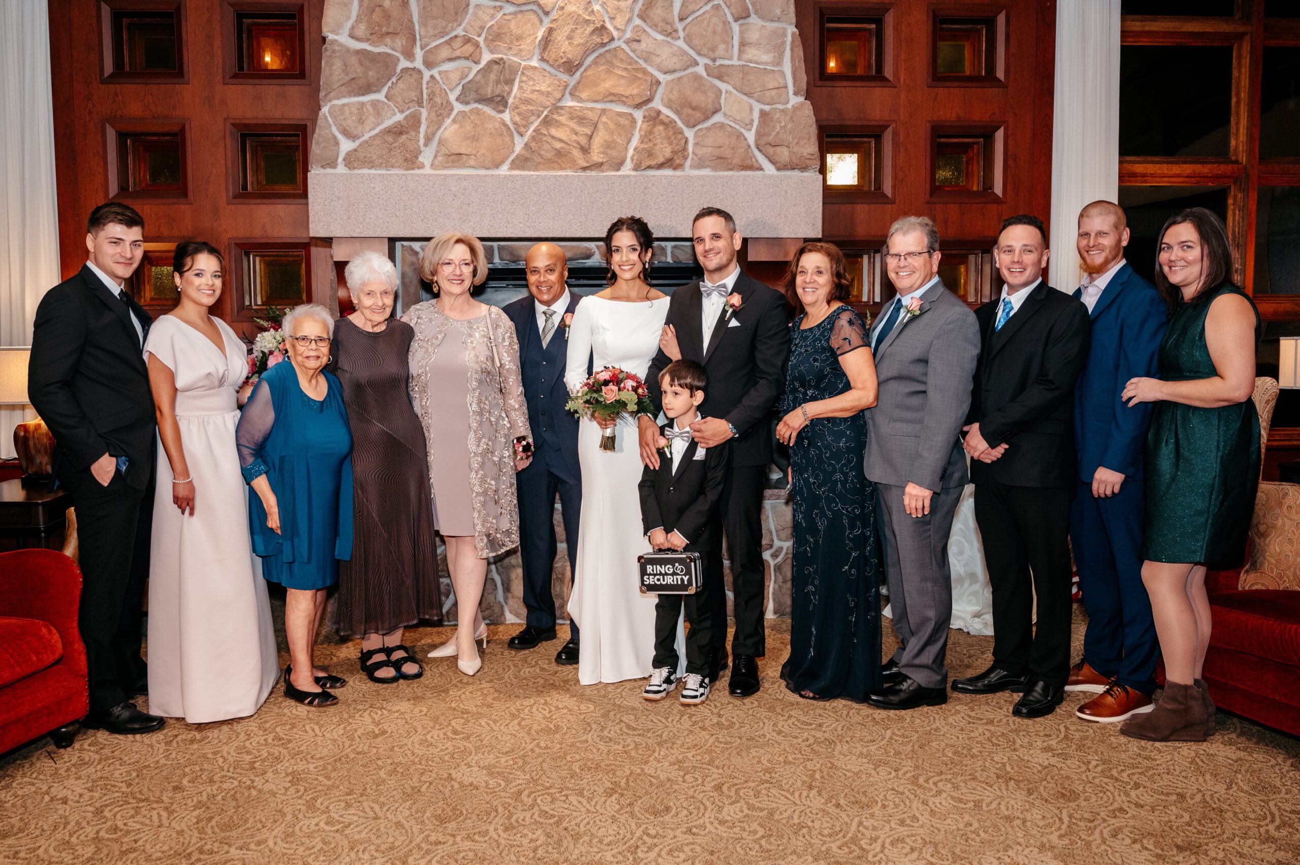 Large family portrait during Cafe Escadrille wedding in Burlington, formal group photo showcasing elegant wedding dress code