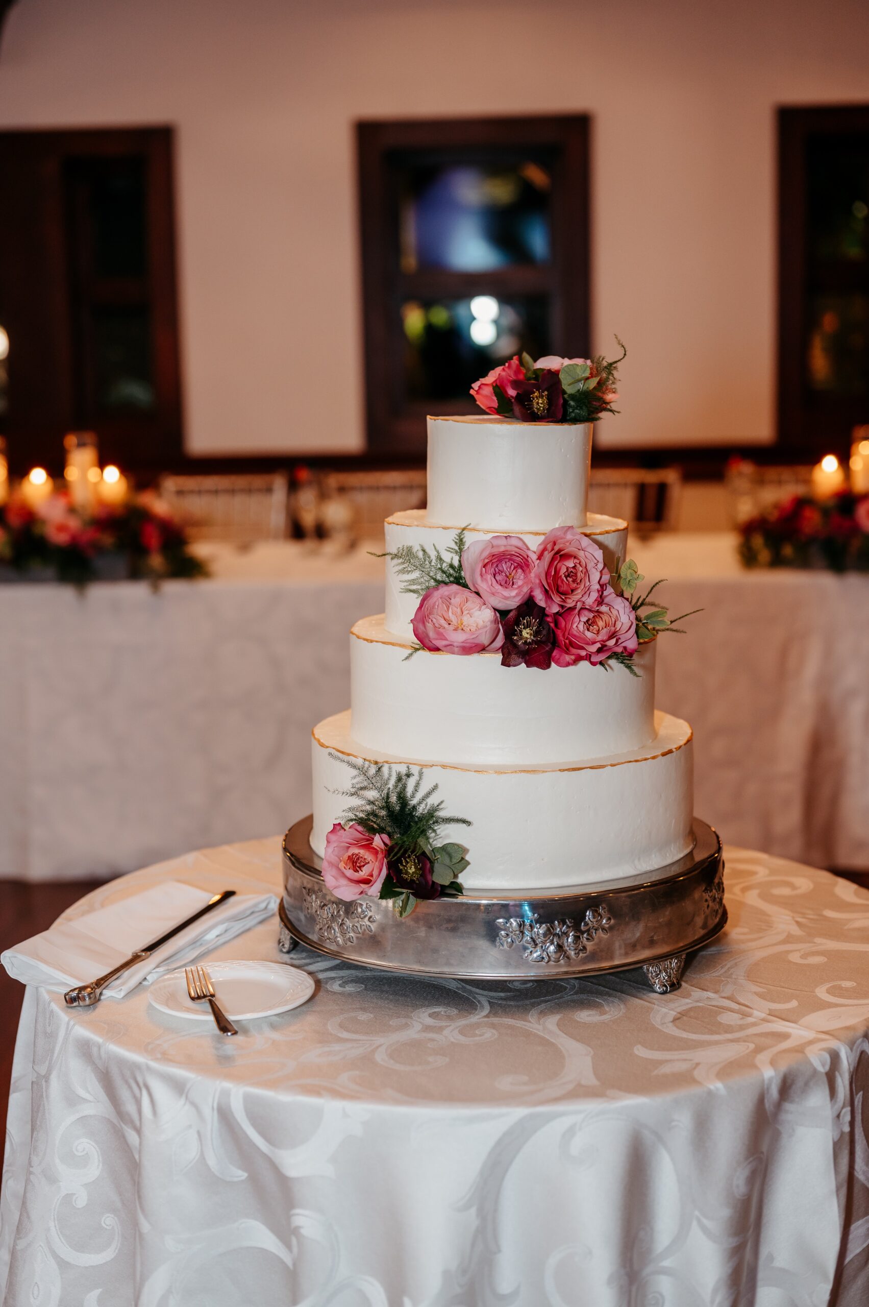 Three-tier floral wedding cake at Cafe Escadrille wedding in Burlington, classic reception detail highlighting catering and wedding cost considerations