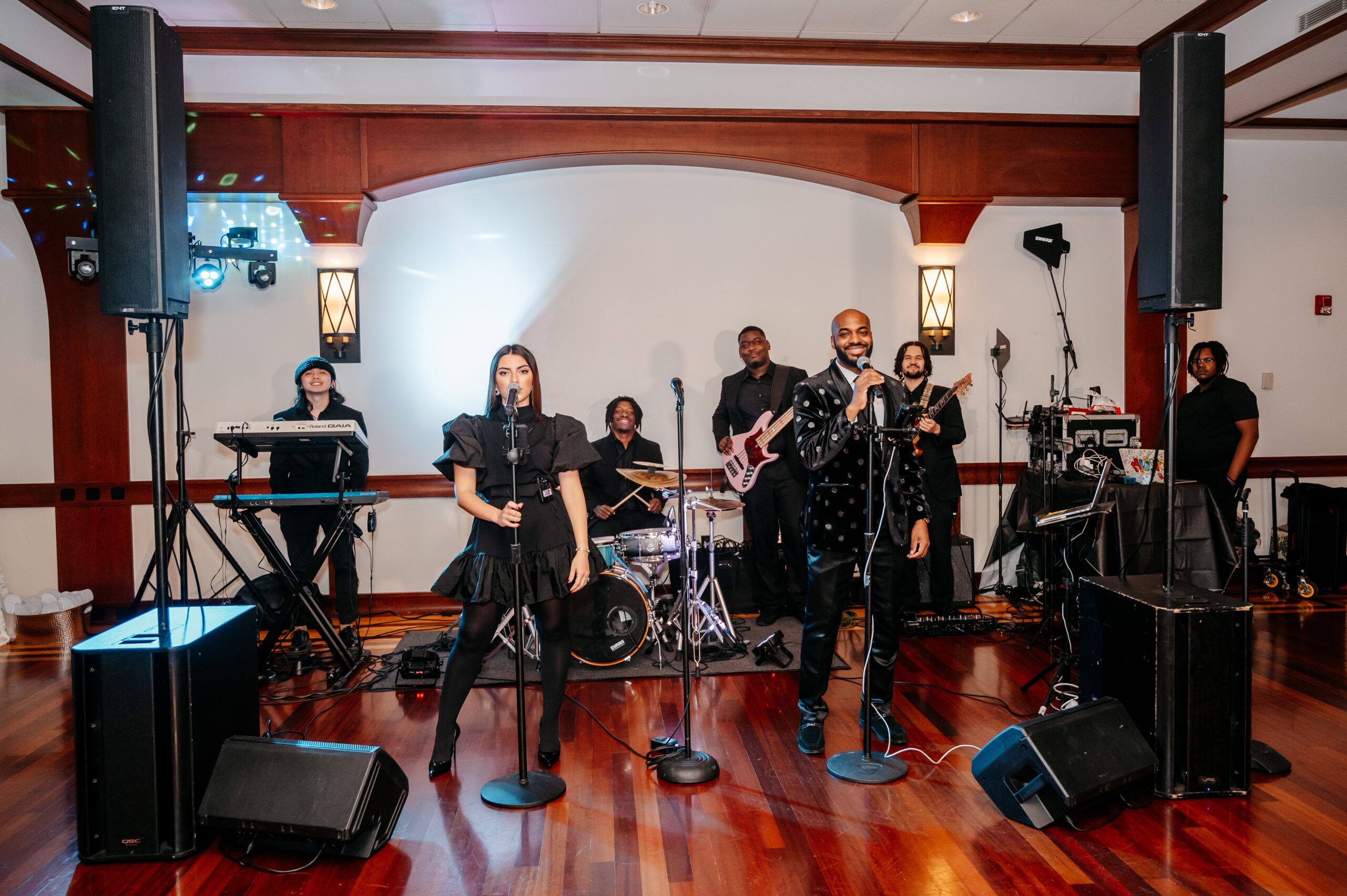 Live wedding band performing at Cafe Escadrille reception in Burlington, showcasing entertainment options and overall wedding cost experience