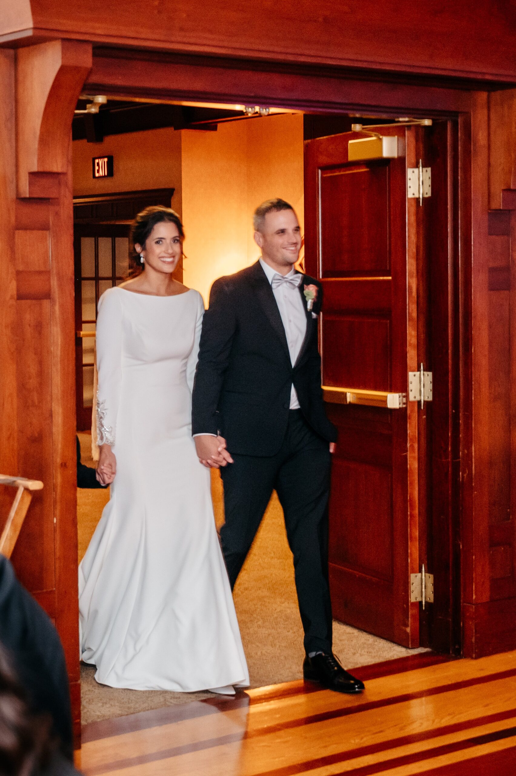 Bride and groom entering reception space at Cafe Escadrille wedding in Burlington, grand entrance moment highlighting venue experience and wedding cost value