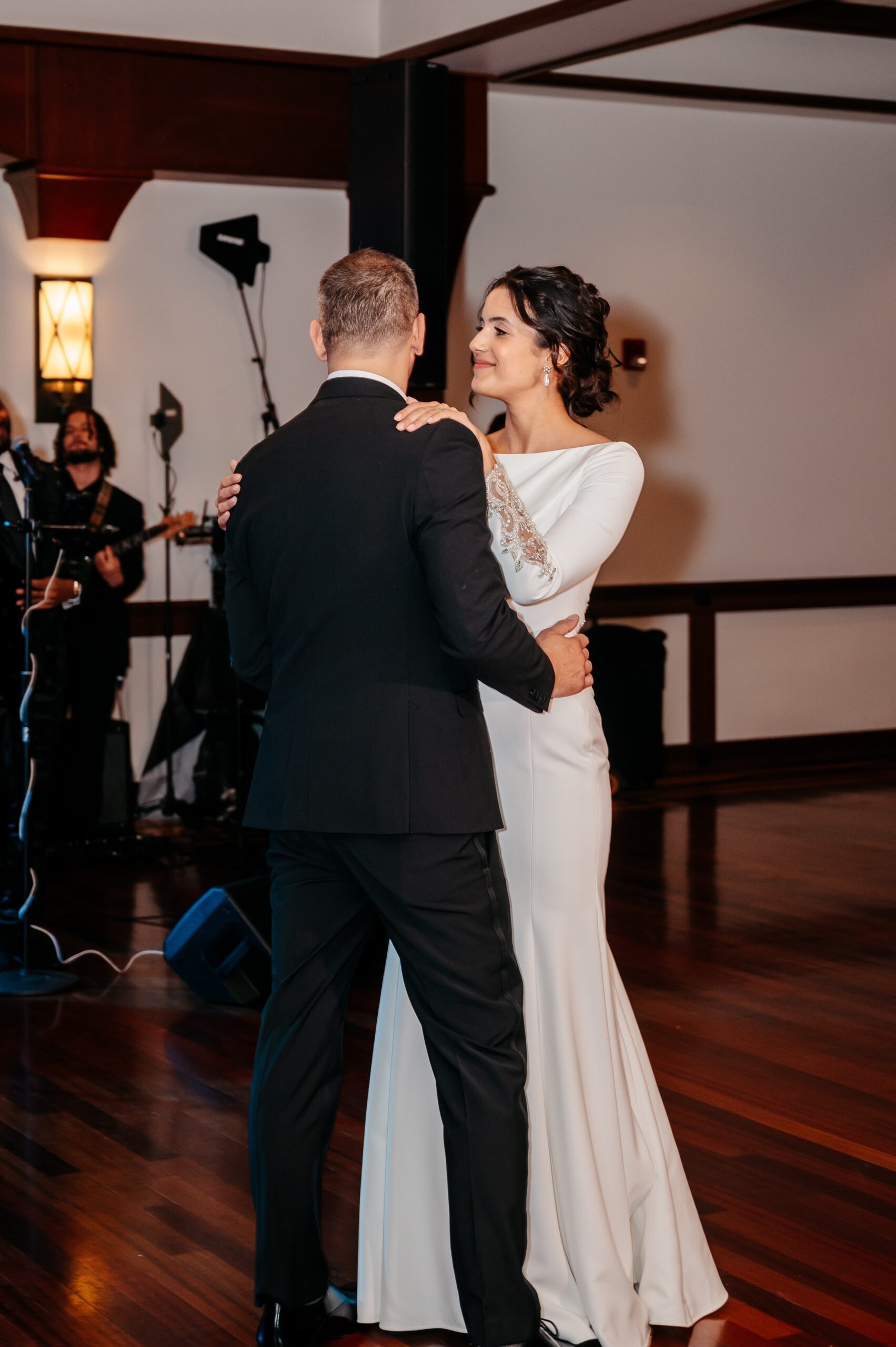 Bride and groom sharing first dance at Cafe Escadrille Burlington wedding reception, intimate moment highlighting venue atmosphere