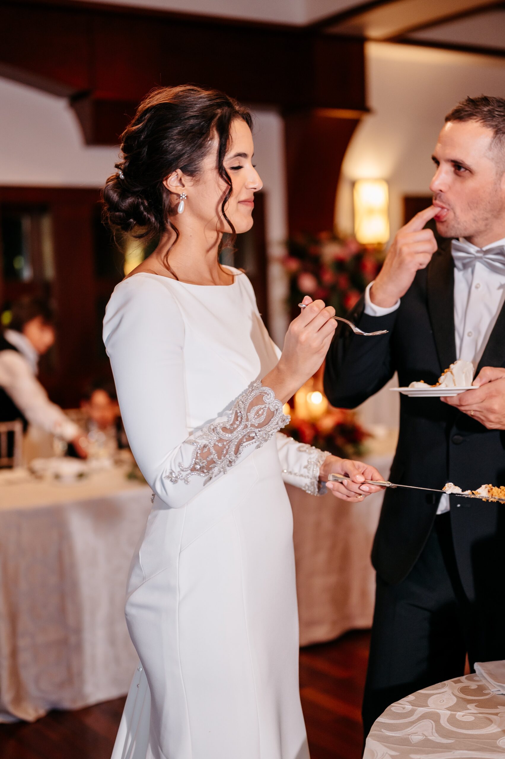 Bride and groom cutting wedding cake at Cafe Escadrille in Burlington, classic reception tradition and catering experience