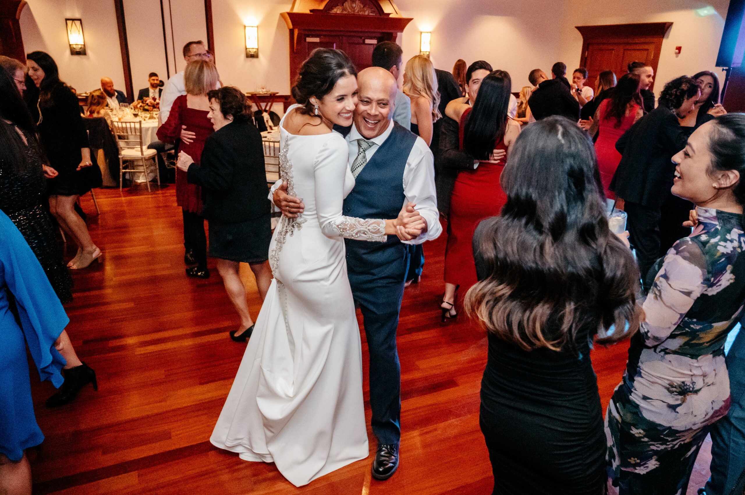 Bride dancing with guests at Cafe Escadrille wedding reception in Burlington, lively dance floor and full wedding experience