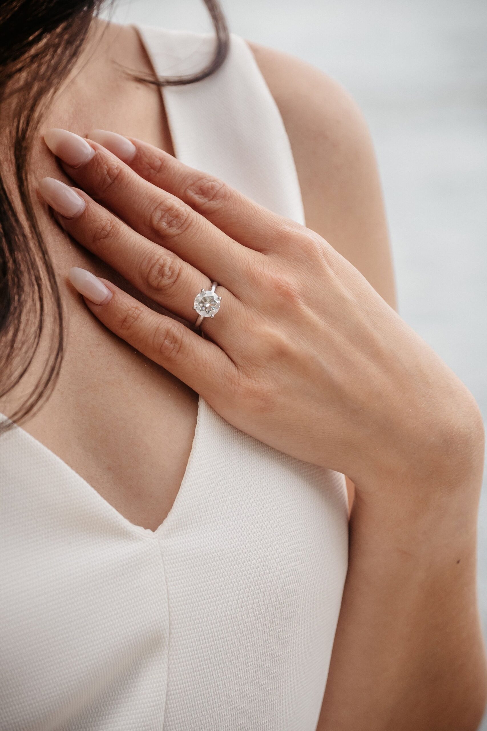 Engagement ring close-up during Fan Pier Park engagement session in Boston, elegant detail captured in soft sunset light