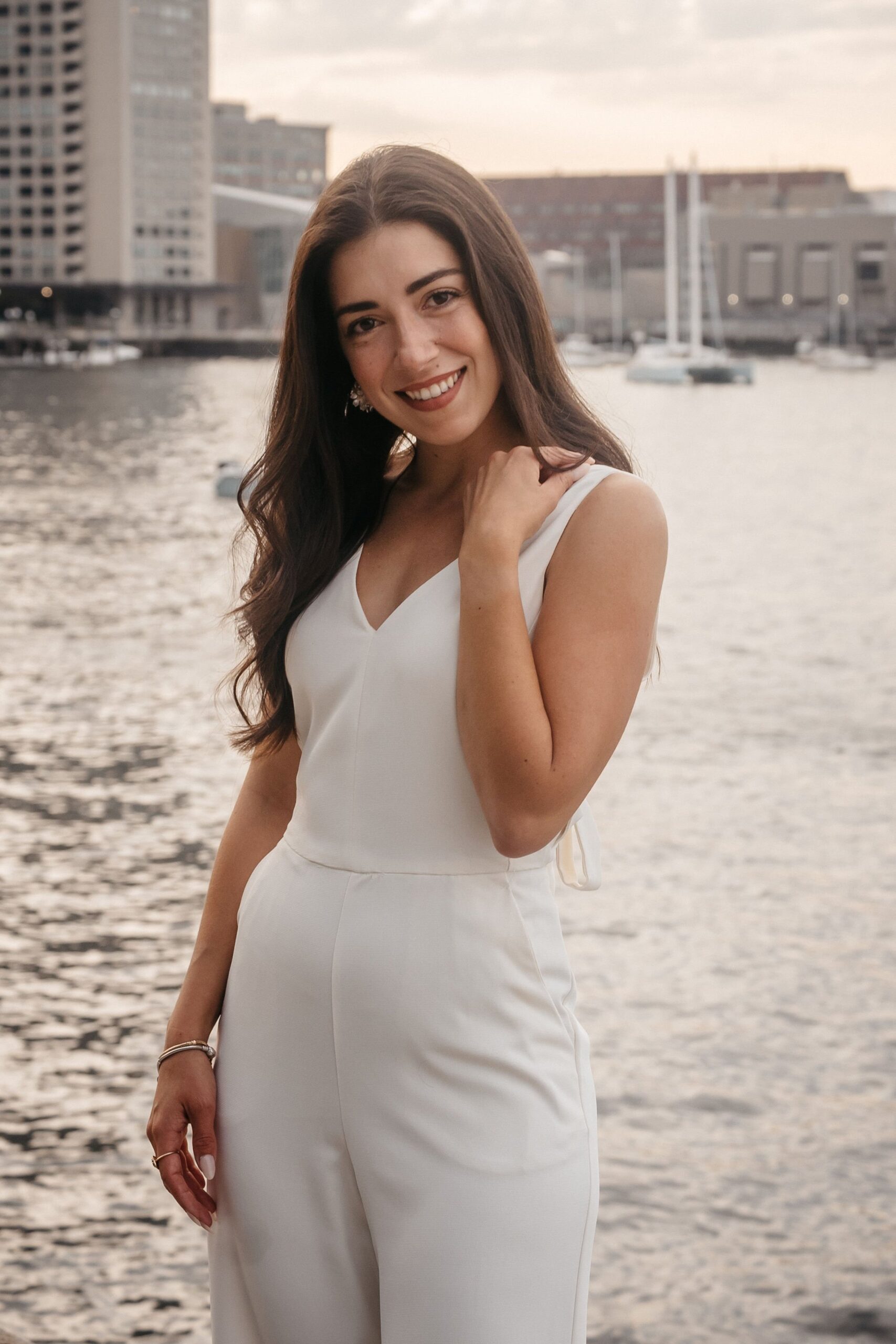 Bride-to-be portrait at Fan Pier Park Boston during engagement session, natural waterfront setting at sunset