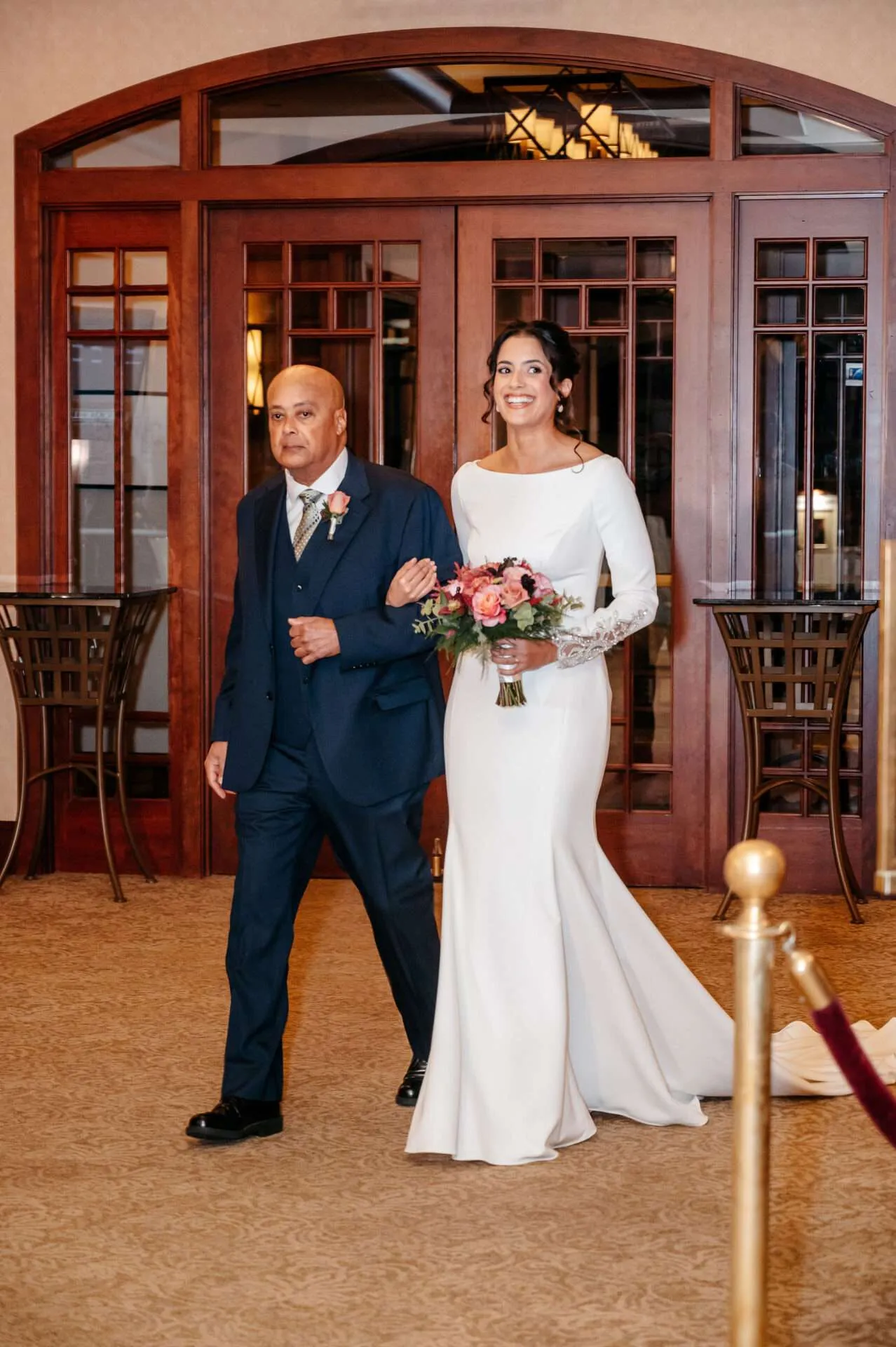 Bride walks down the aisle with her father at Burlingon wedding locations