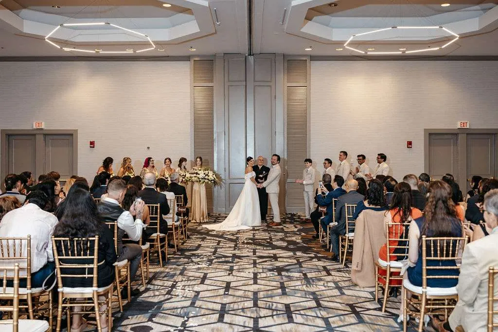 Bride and groom stand at the alter and smile at their wedding ceremony in unique Burlington wedding locations