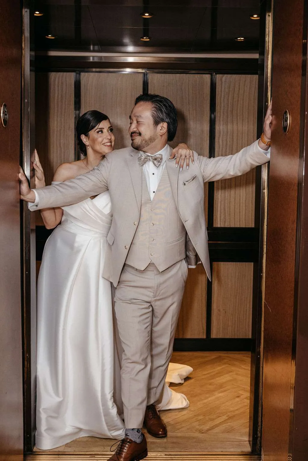 Bride and groom pose in elevator for picture in Burlington wedding locations