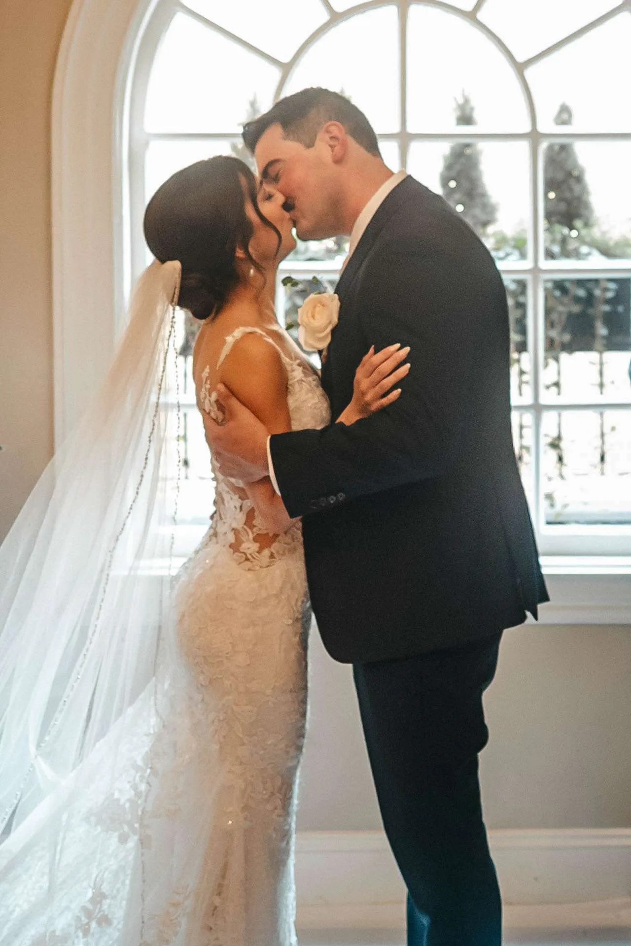 Bride and groom share a kiss while getting married in massachusetts