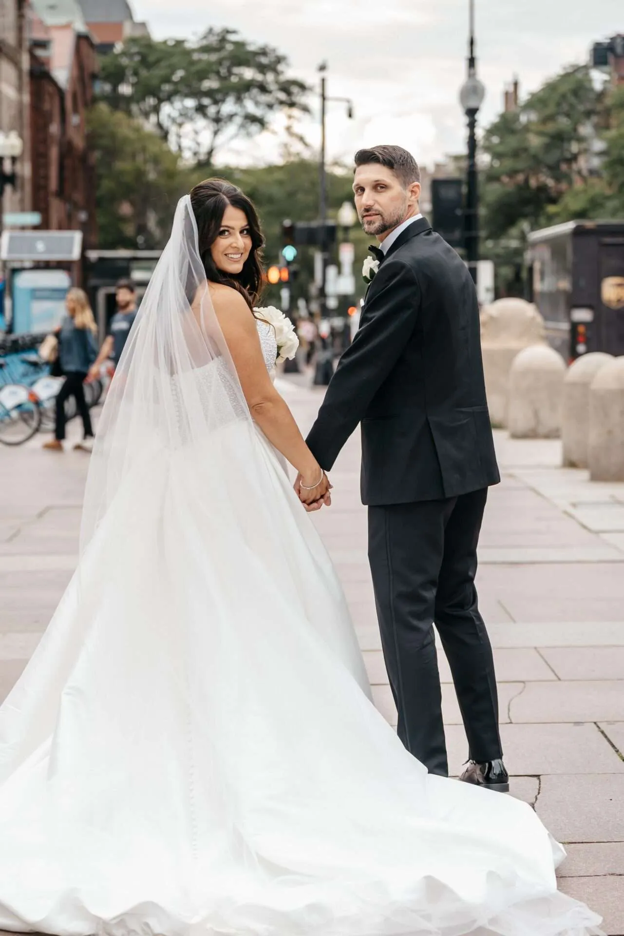 Bride and groom look back at photographer while getting married in massachusetts