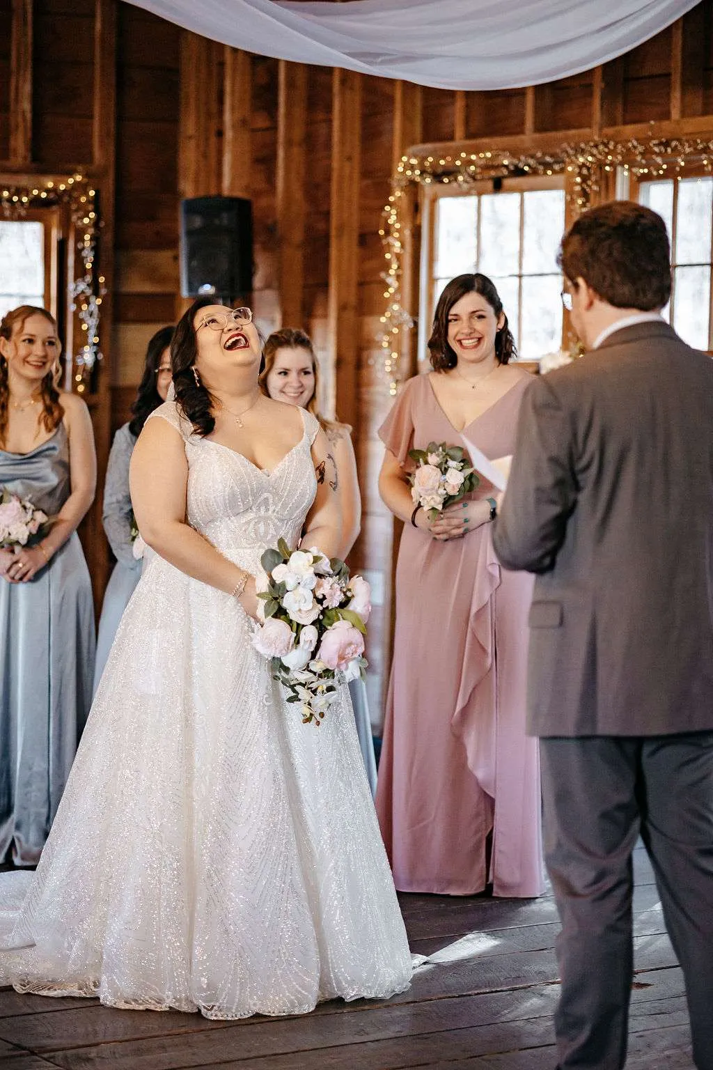 Bride laughs with bridesmaids at the average Boston wedding cost