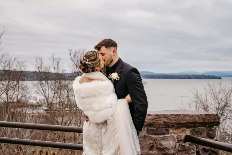 Bride and Groom share a kiss in front of the harbor after learning about the average wedding cost in Boston