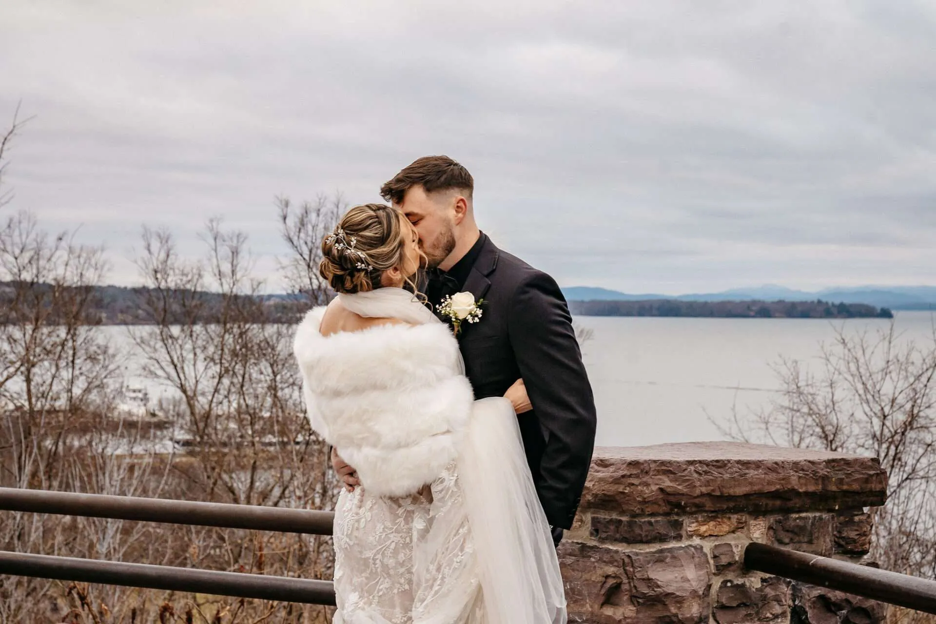 Bride and Groom share a kiss in front of the harbor after learning about the average wedding cost in Boston