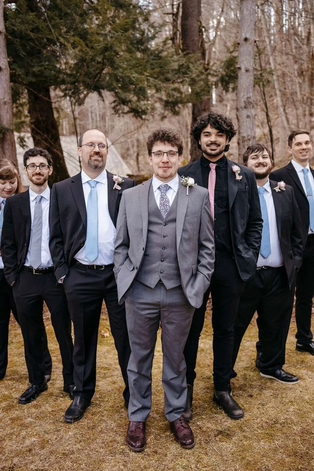 Groom and groomsman pose and smile for pictures in Burlington wedding locations