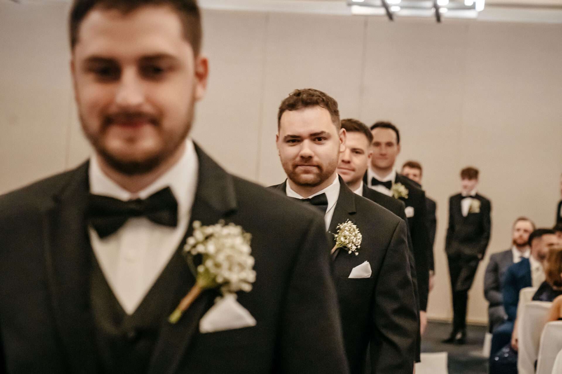 Groomsman smirks at the camera unique Burlington wedding locations