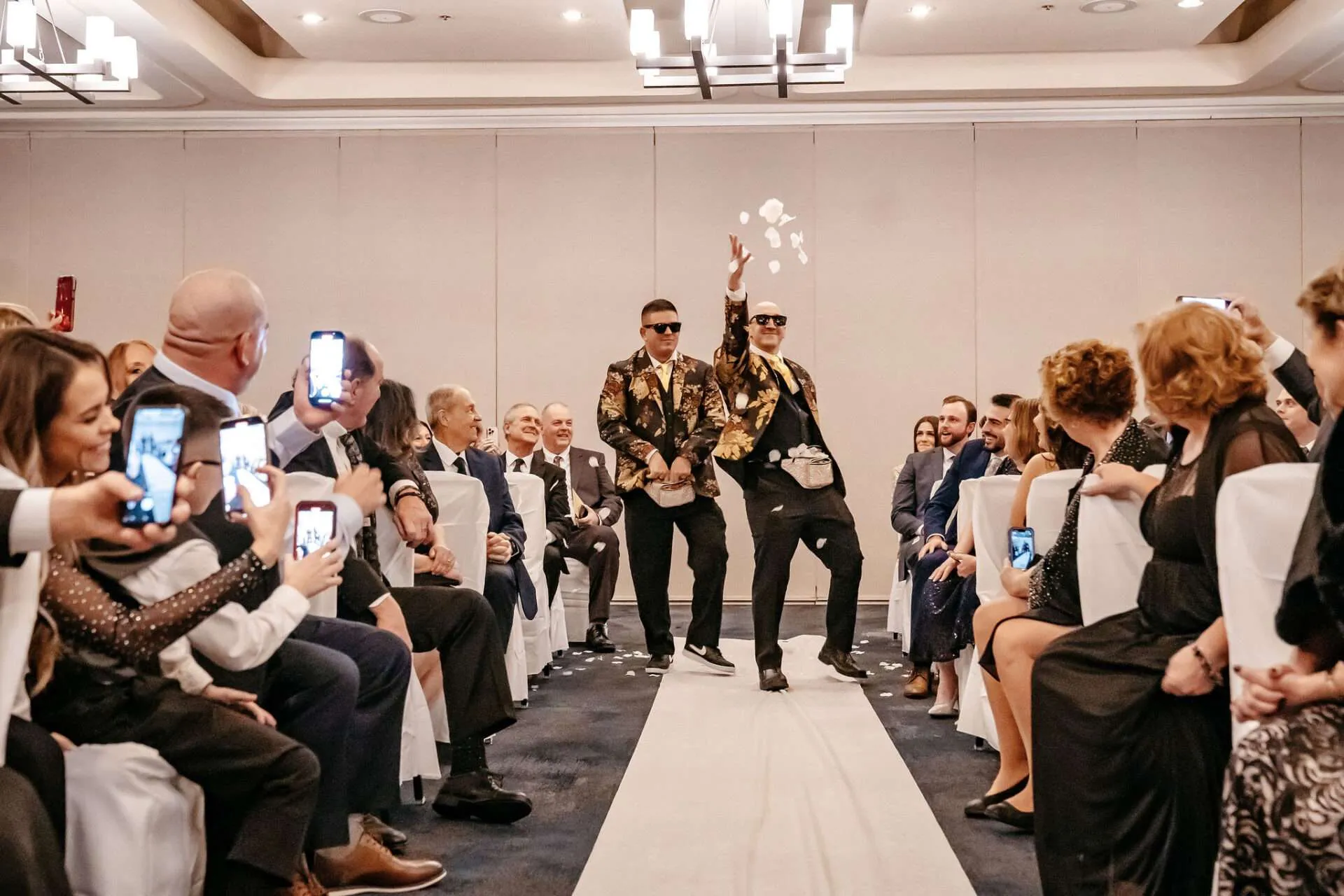 Groomsman throw flowers while walking down the aisle and might not know the average wedding photographre cost in Boston