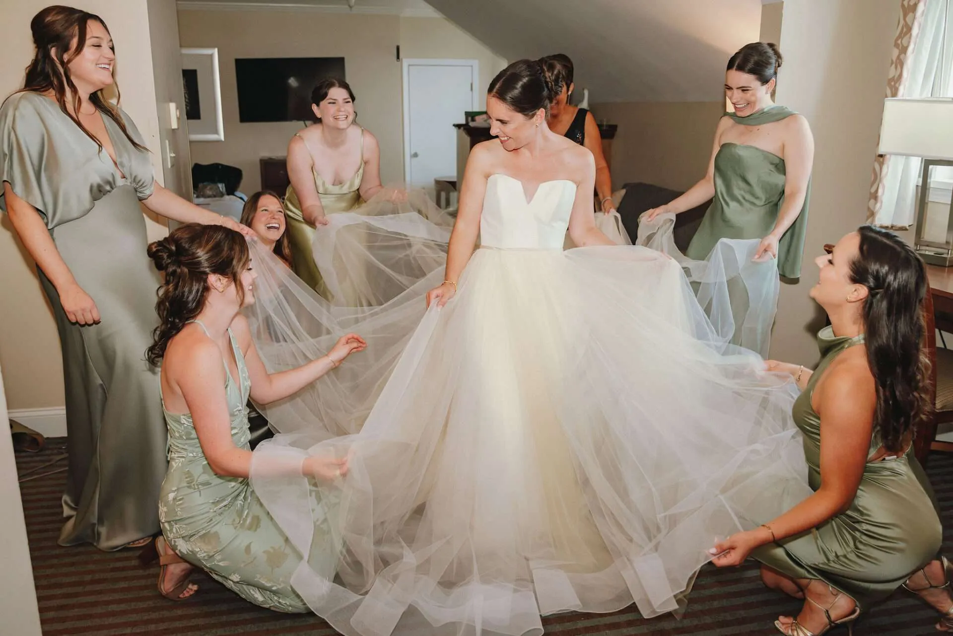A bride celebrates with her bridesmaids before her wedding at her Boston Seaport wedding venue