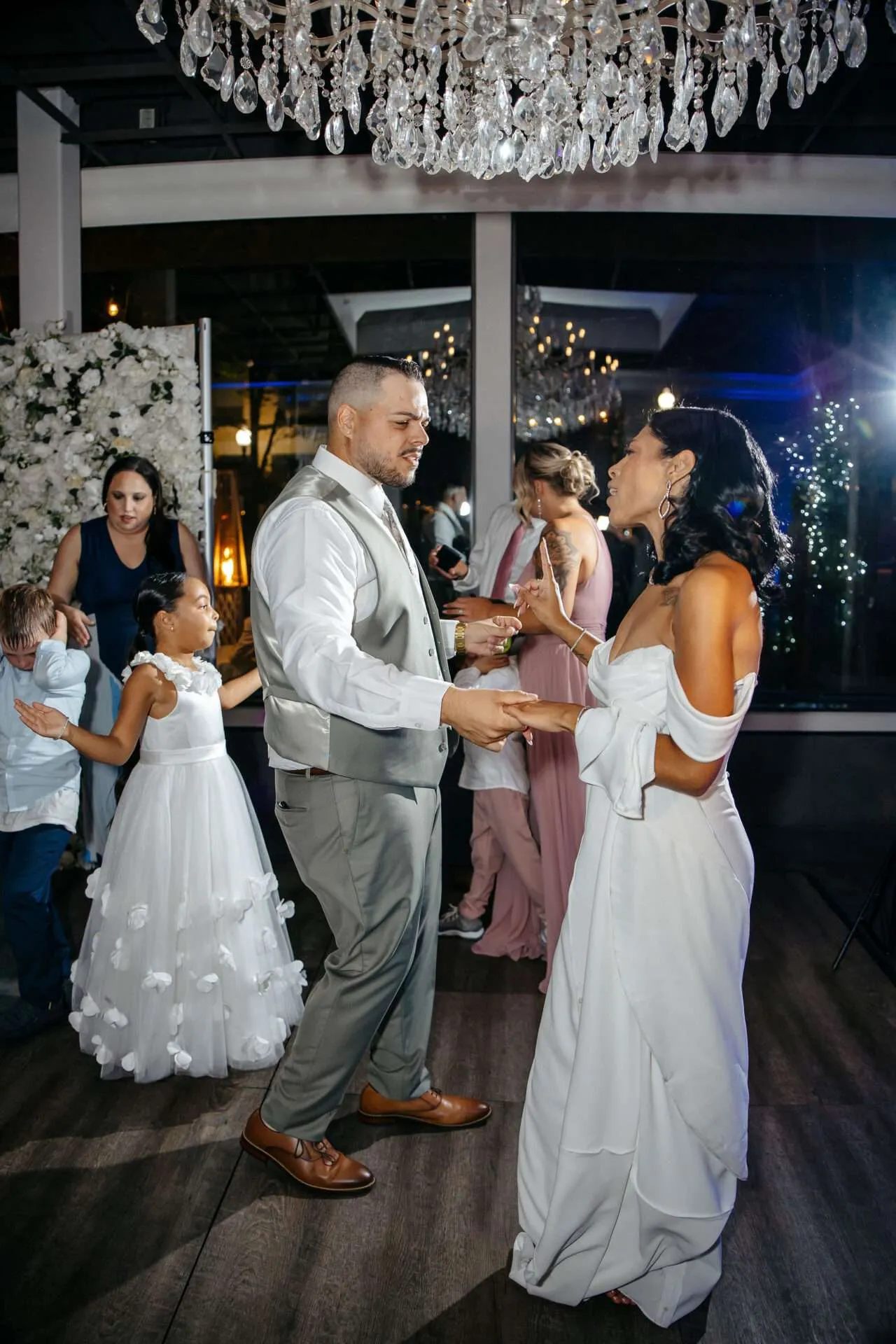 A bride and groom dance together at their reception at their Seaport village wedding venues